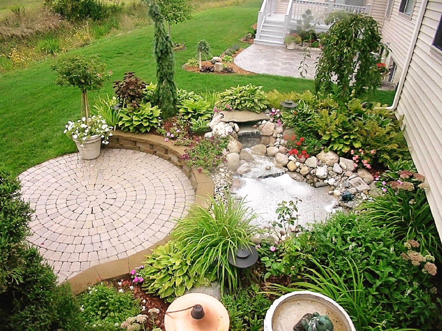  patio with pavers, retaining wall and garden. Aquascape and landscape design by H&amp;M Landscapers 