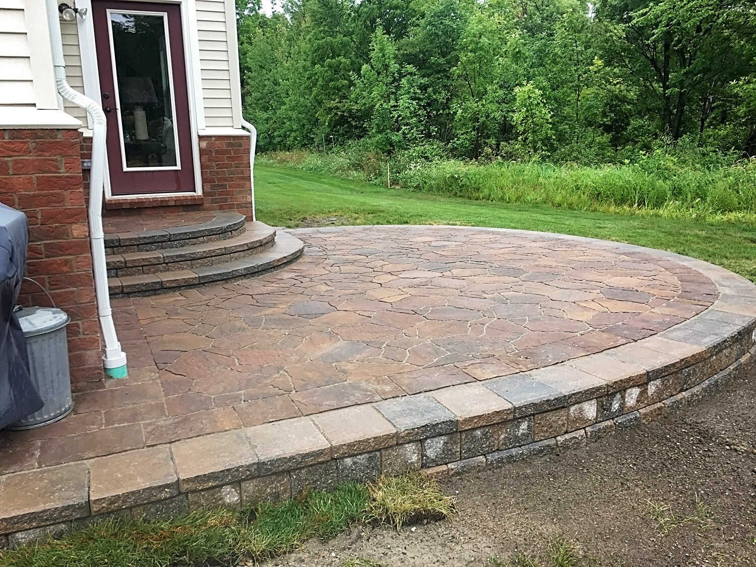  raised patio with pavers and edging | grading, drainage, downspouts H&amp;M Landscaping 