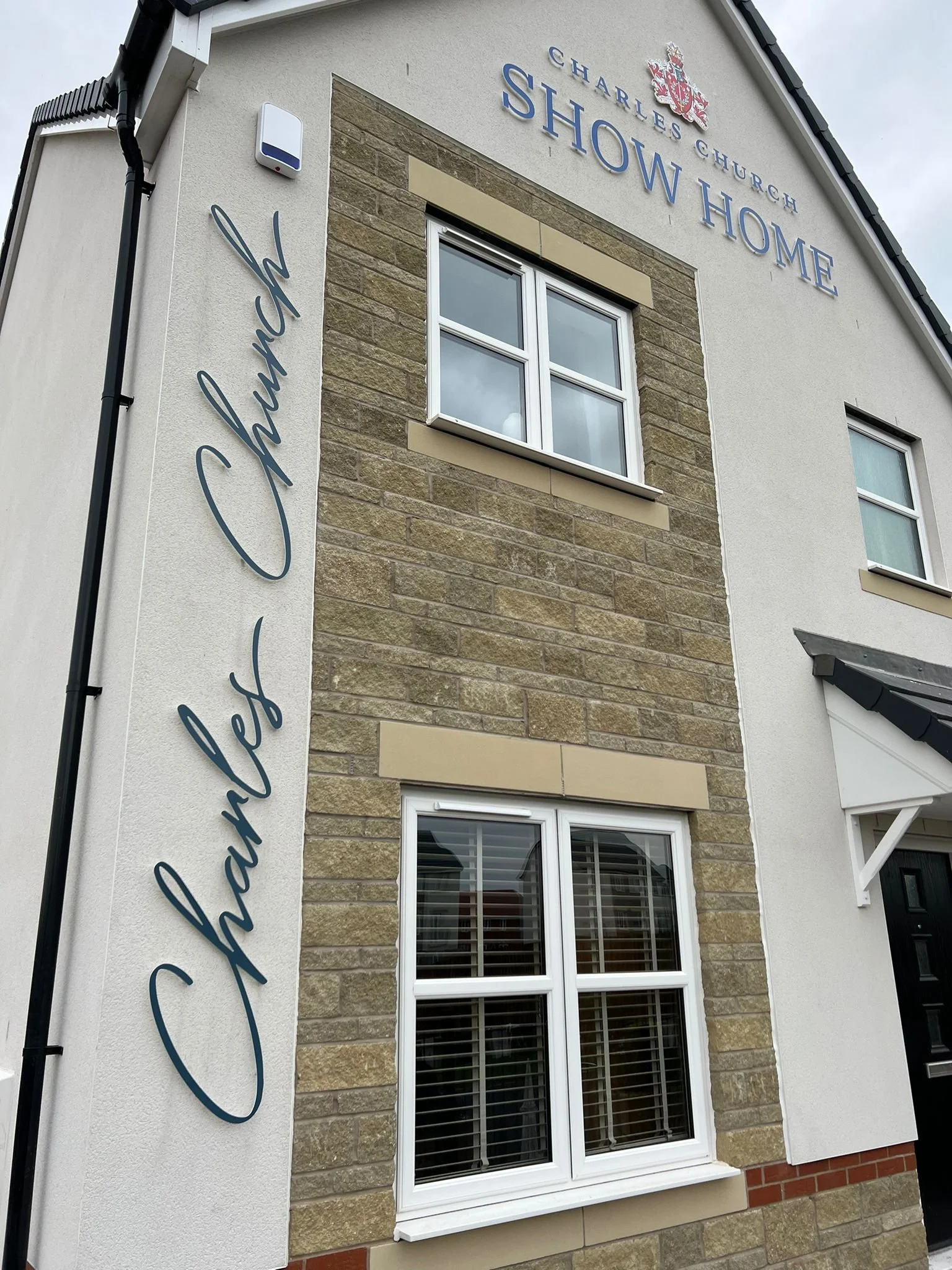 Professional installation of large-scale built-up letters for a home builder client Charles Church.