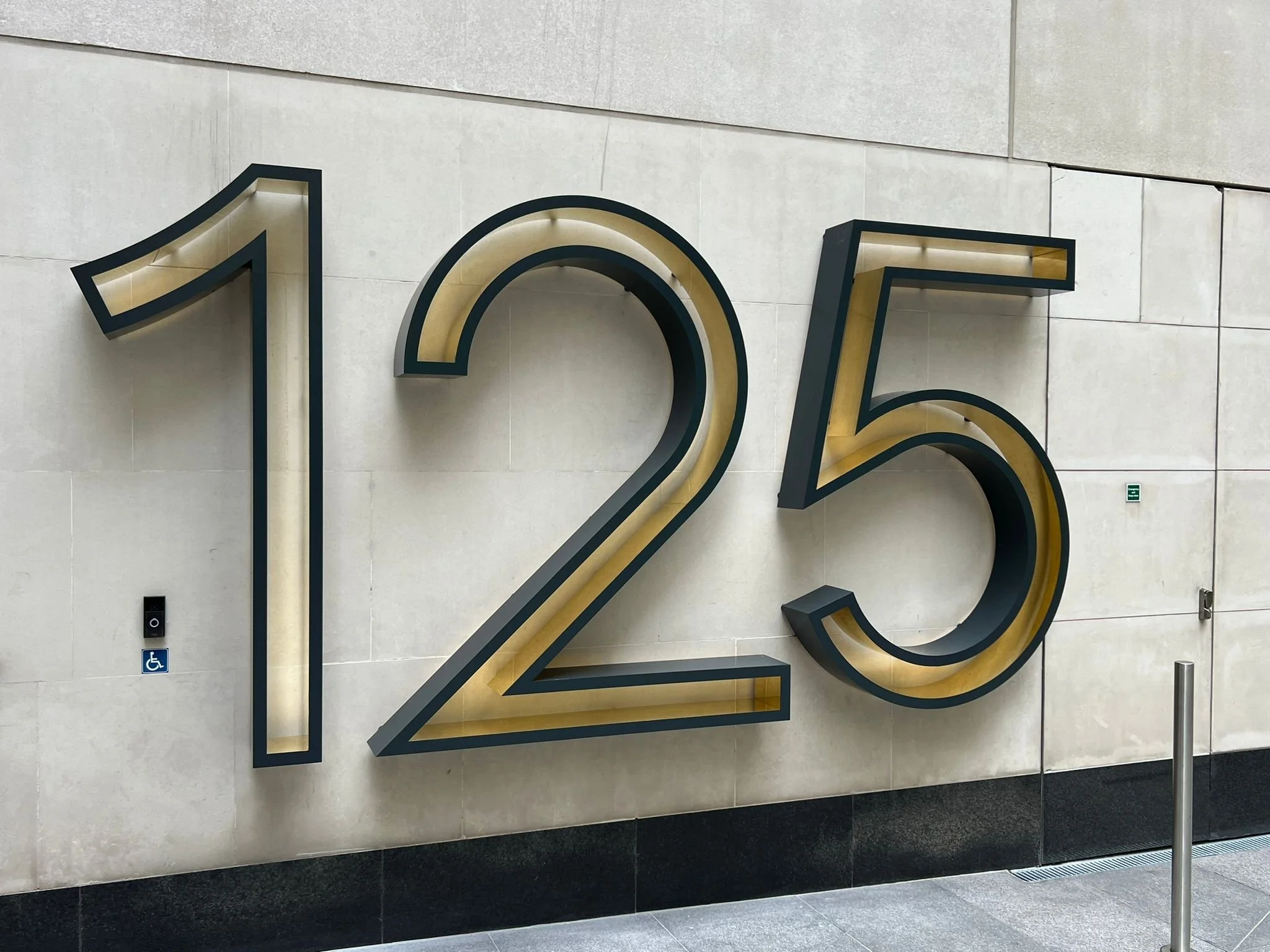 Large scale built-up 3D lettering for exterior office signage with clean precision-cut metal edges.