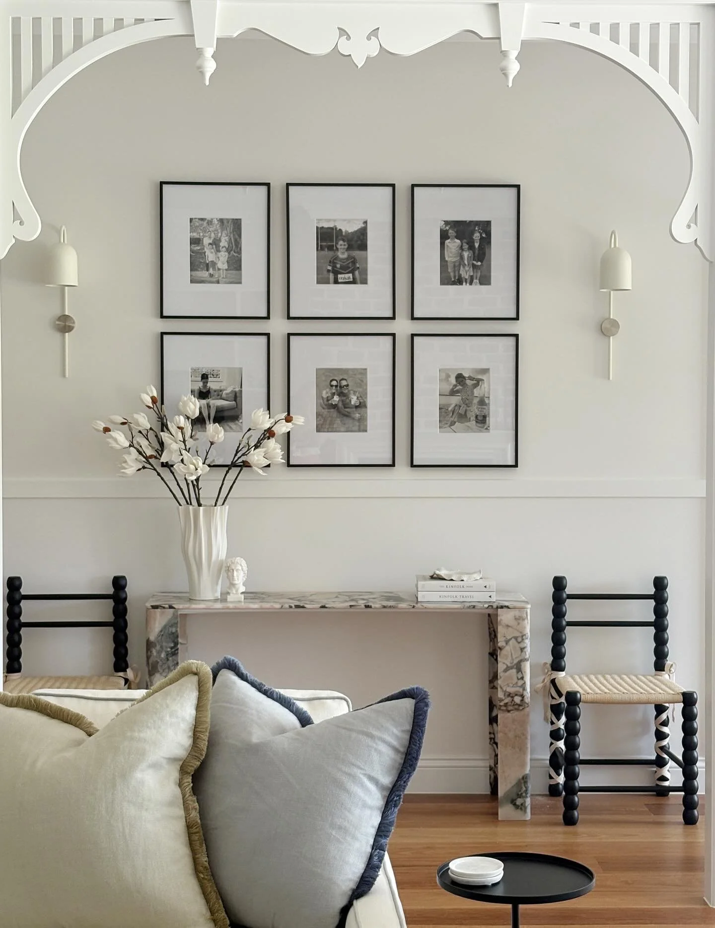 Perfectly framed by classic Queenslander fretwork, this entry is a quiet study in balance. Heritage charm and modernity, structure and softness. Add a gallery of precious family moments and you get a little glimpse into how thoughtful layers can turn