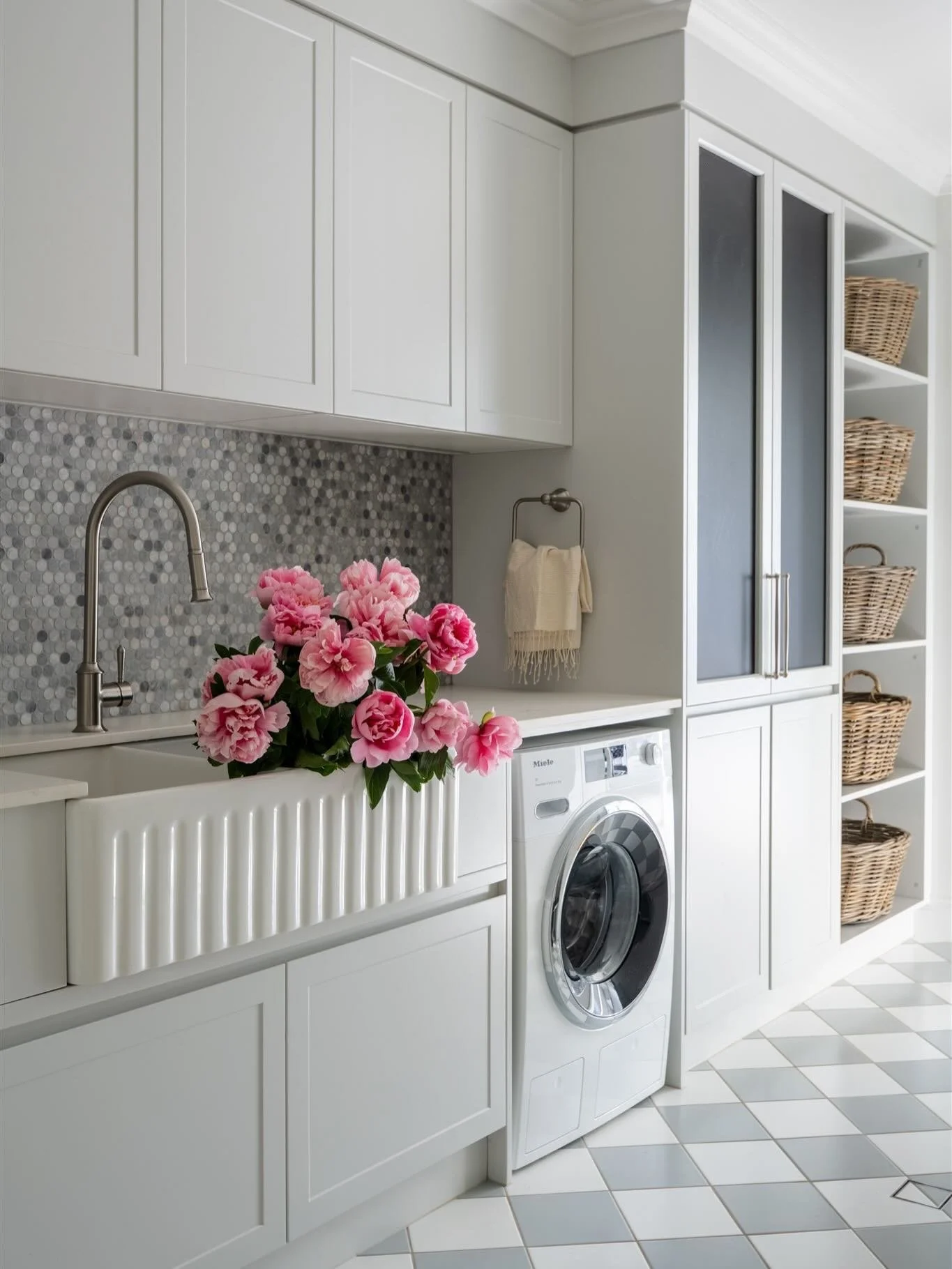 A laundry designed to make everyday routines feel effortless. 

With a generous double farmhouse sink, thoughtful storage at every turn and zones for washing, drying and sorting, this space works hard without feeling clinical. From personalised hooks