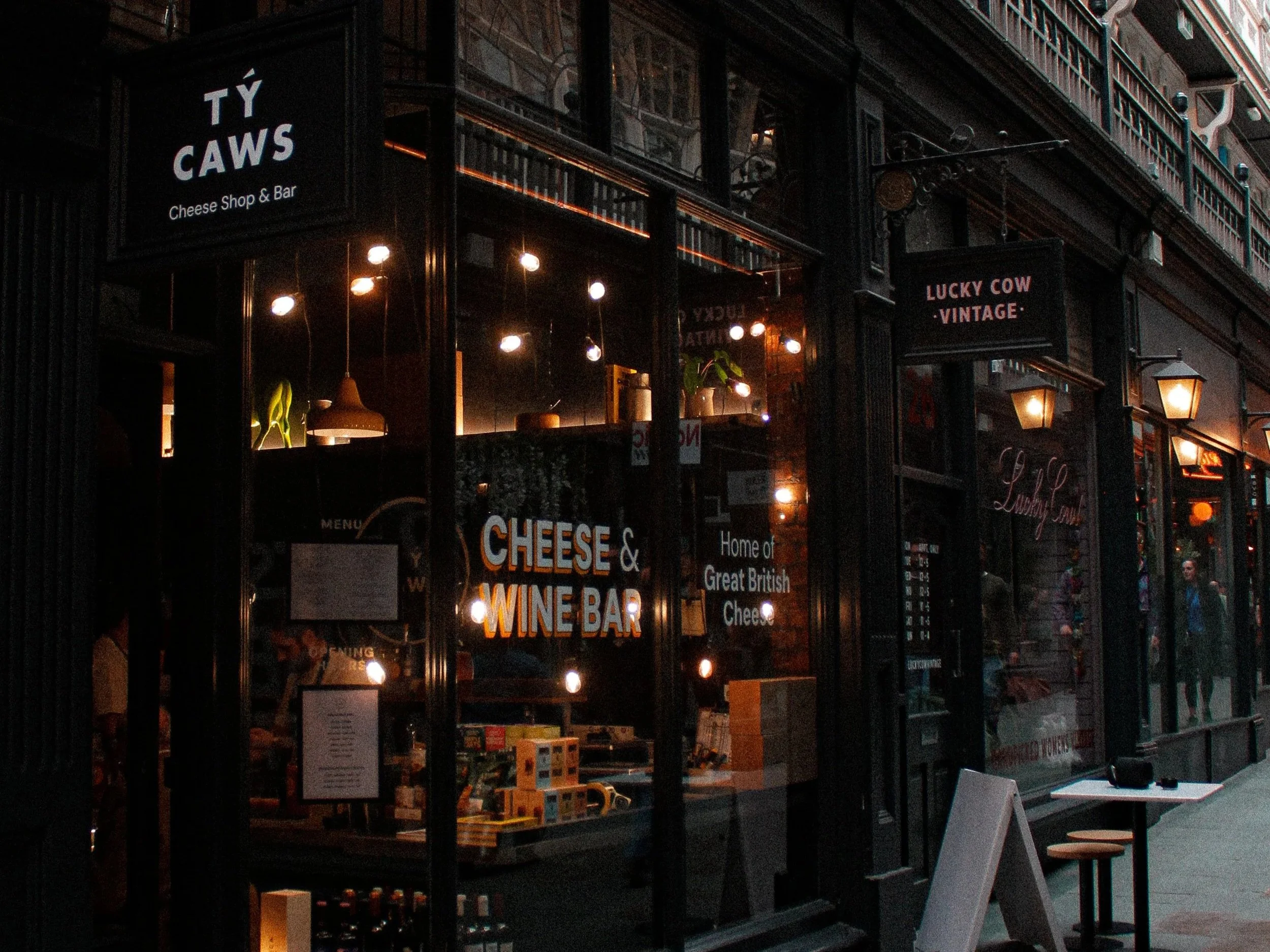 The image shows the exterior of a cheese shop and wine bar called Tŷ Caws in Castle Arcade Cardiff