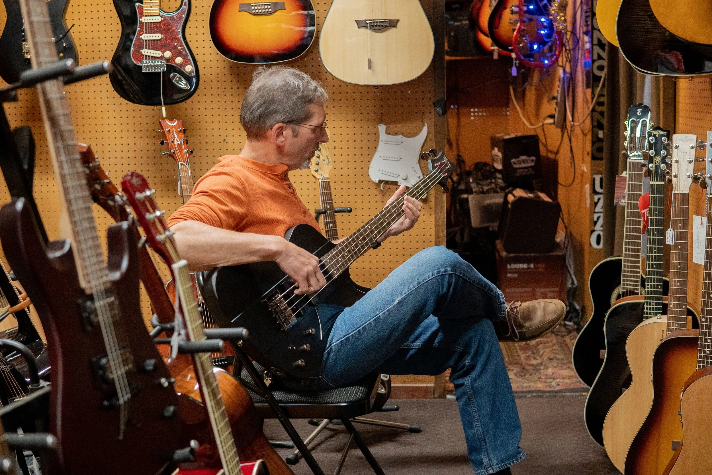 Man playing guitar at Buzzo Music.jpg