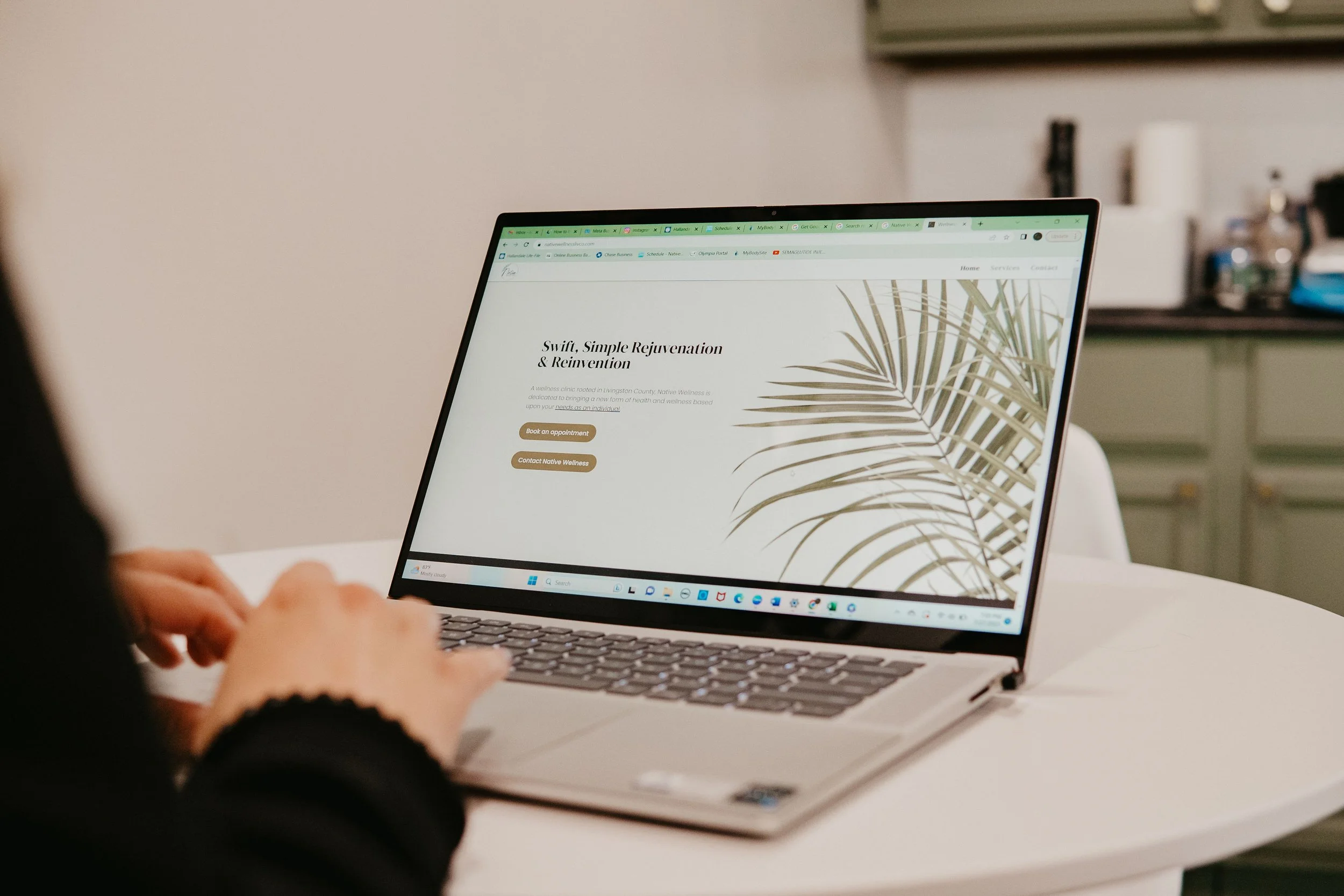 Hands on laptop native wellness website home.jpg