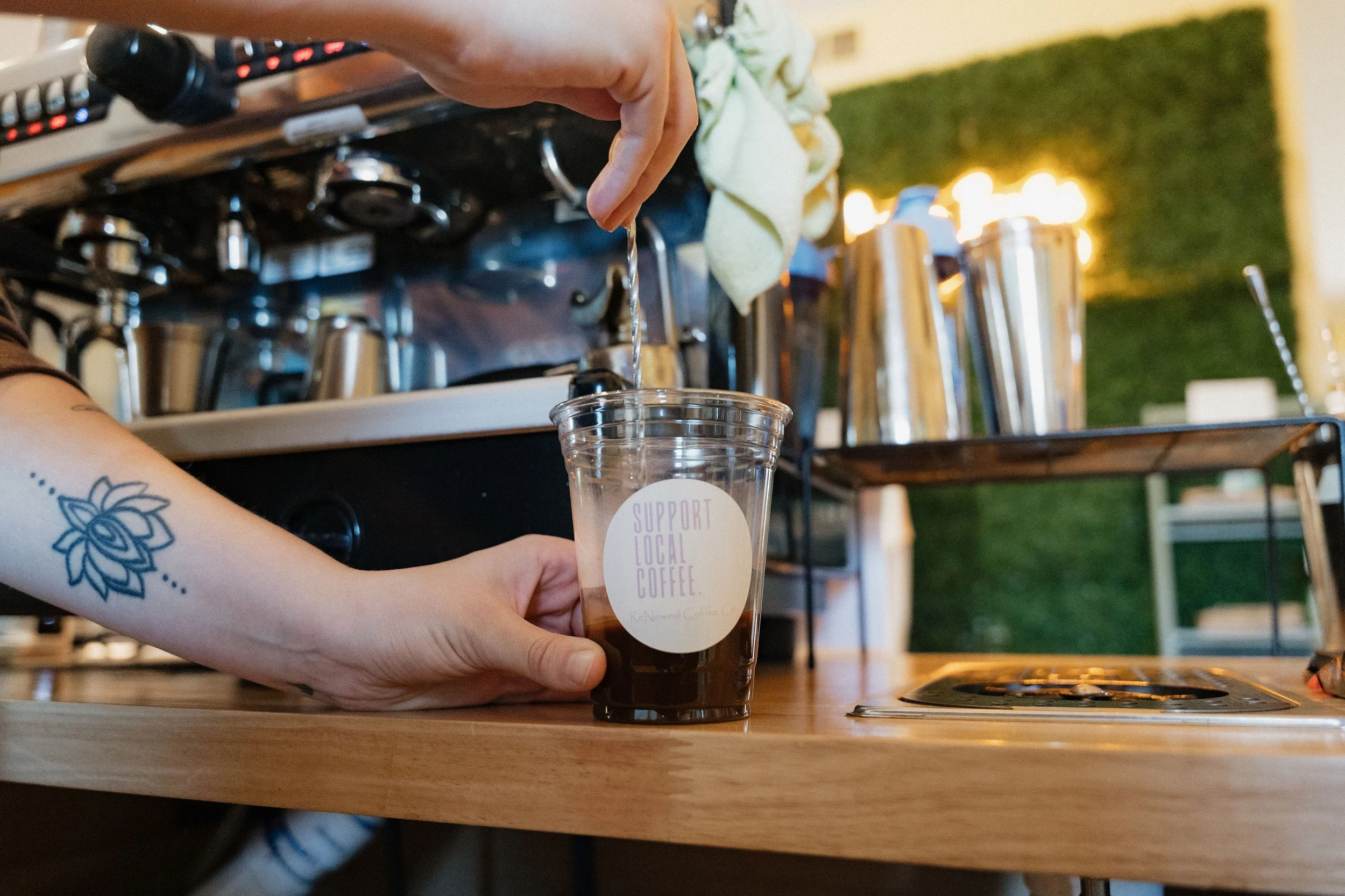 Employee pours iced coffee at ReNewed Coffee Co Mount Morris.jpg