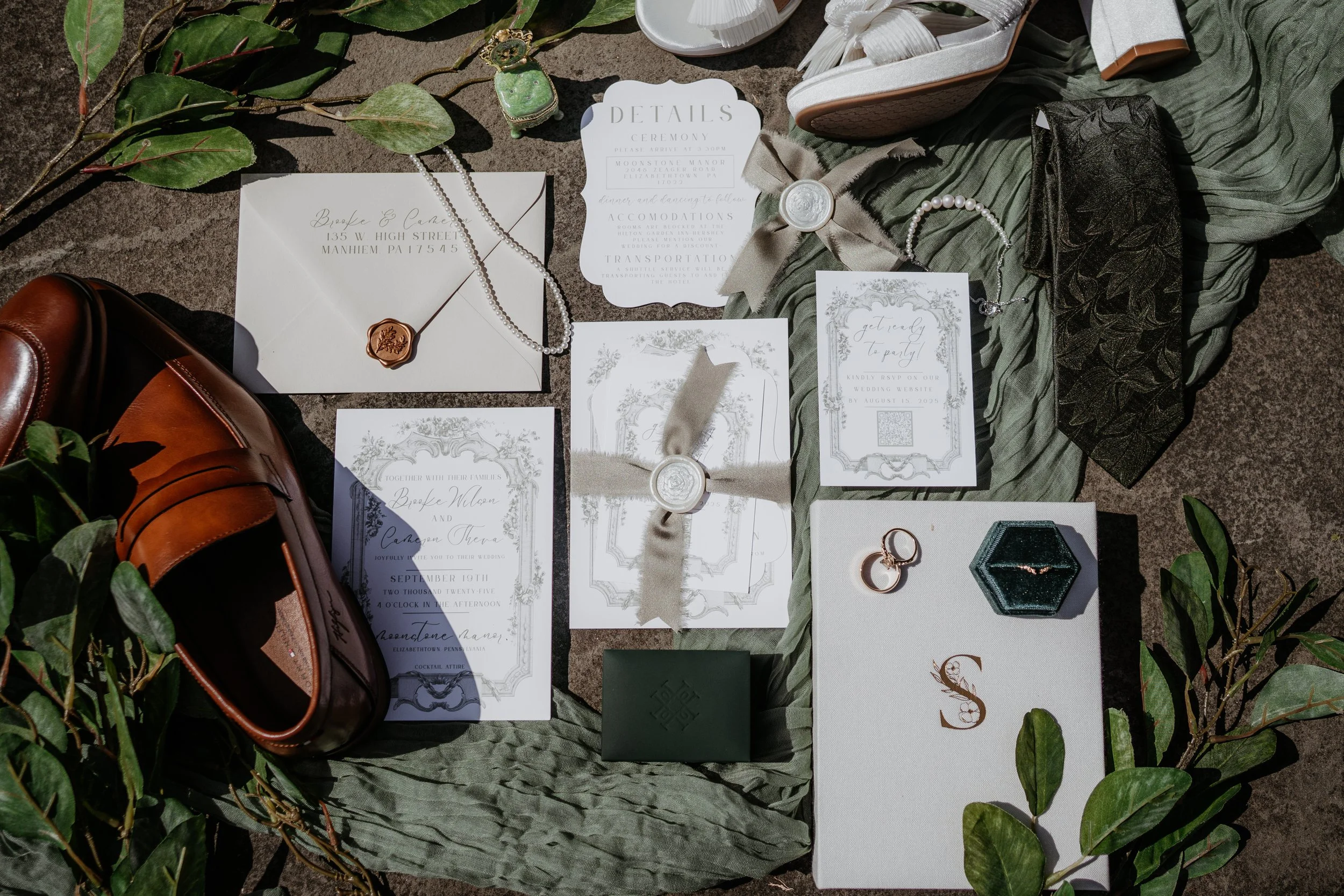 various wedding details laid out in a flat lay at moonstone manor
