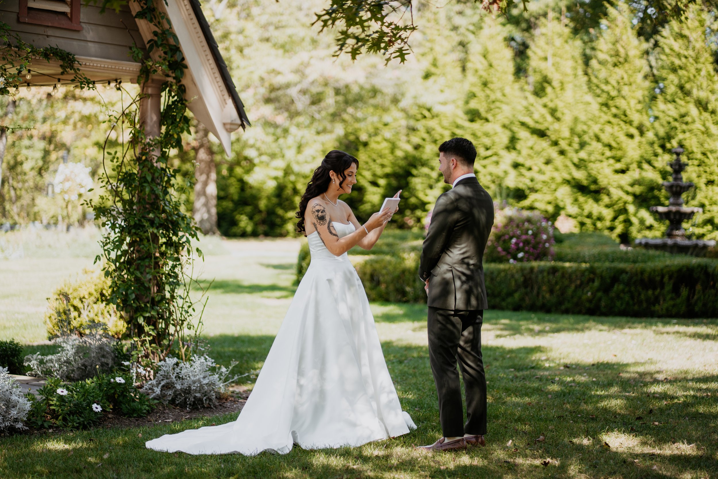 bride and groom read private vows in the gardens of moonstone manor wedding venue