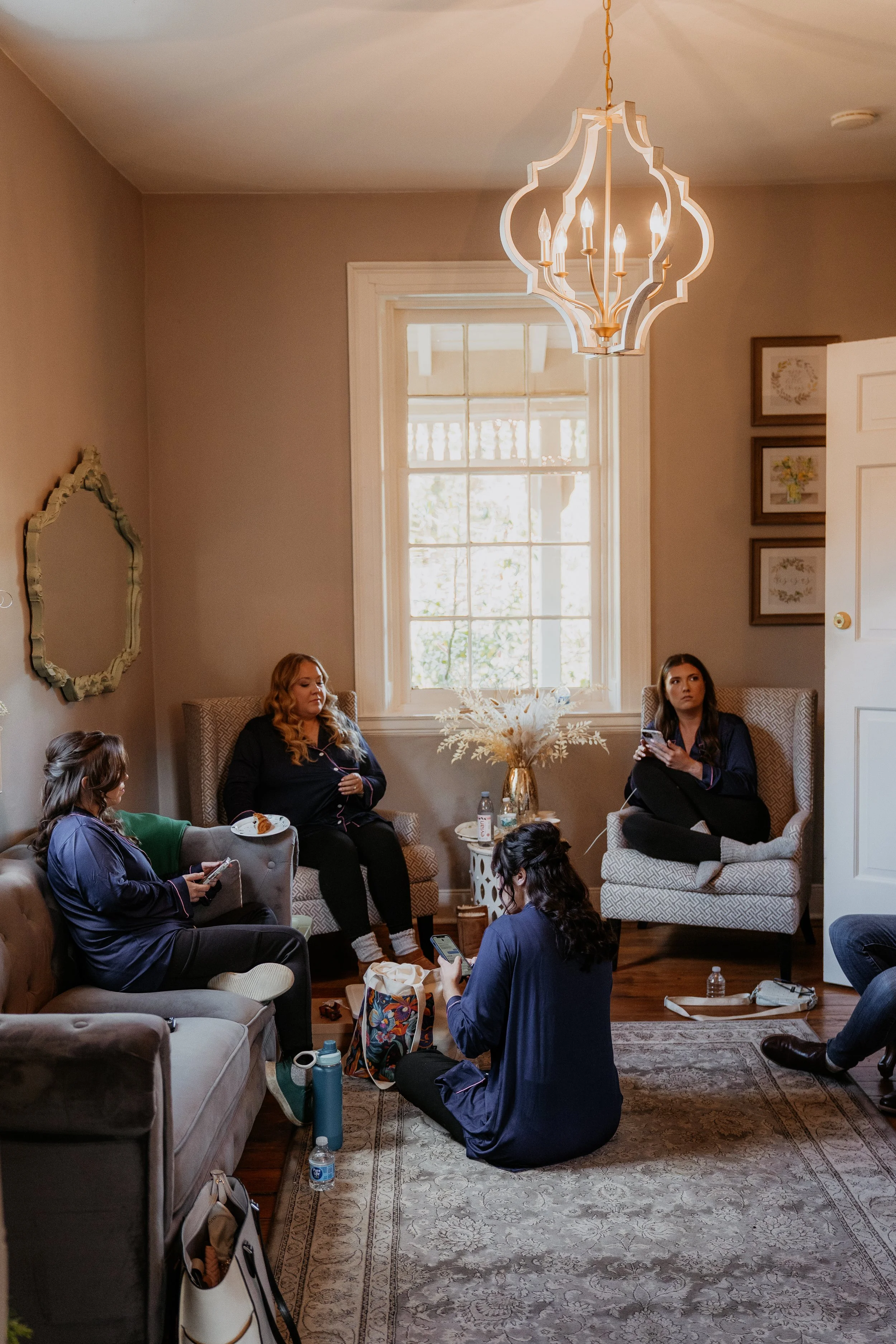 bridesmaids hanging out together in the house before they start getting ready for the wedding day at Stone Mill Inn