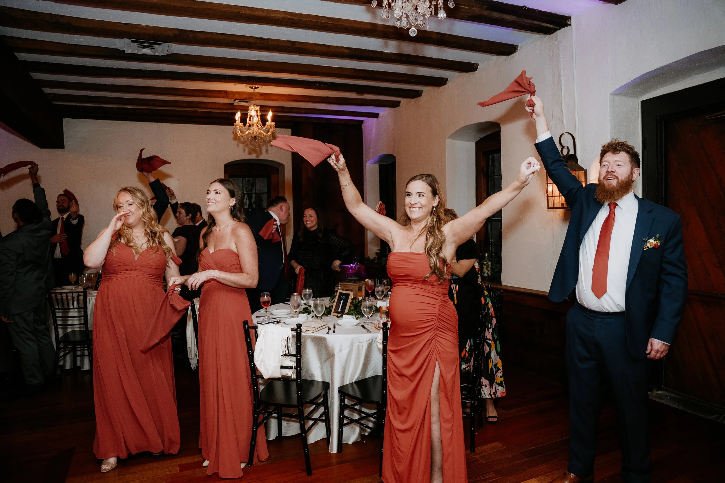 wedding guests celebrating bride and grooms entrance into they reception space at the Stone Mill Inn in Hallam, PA