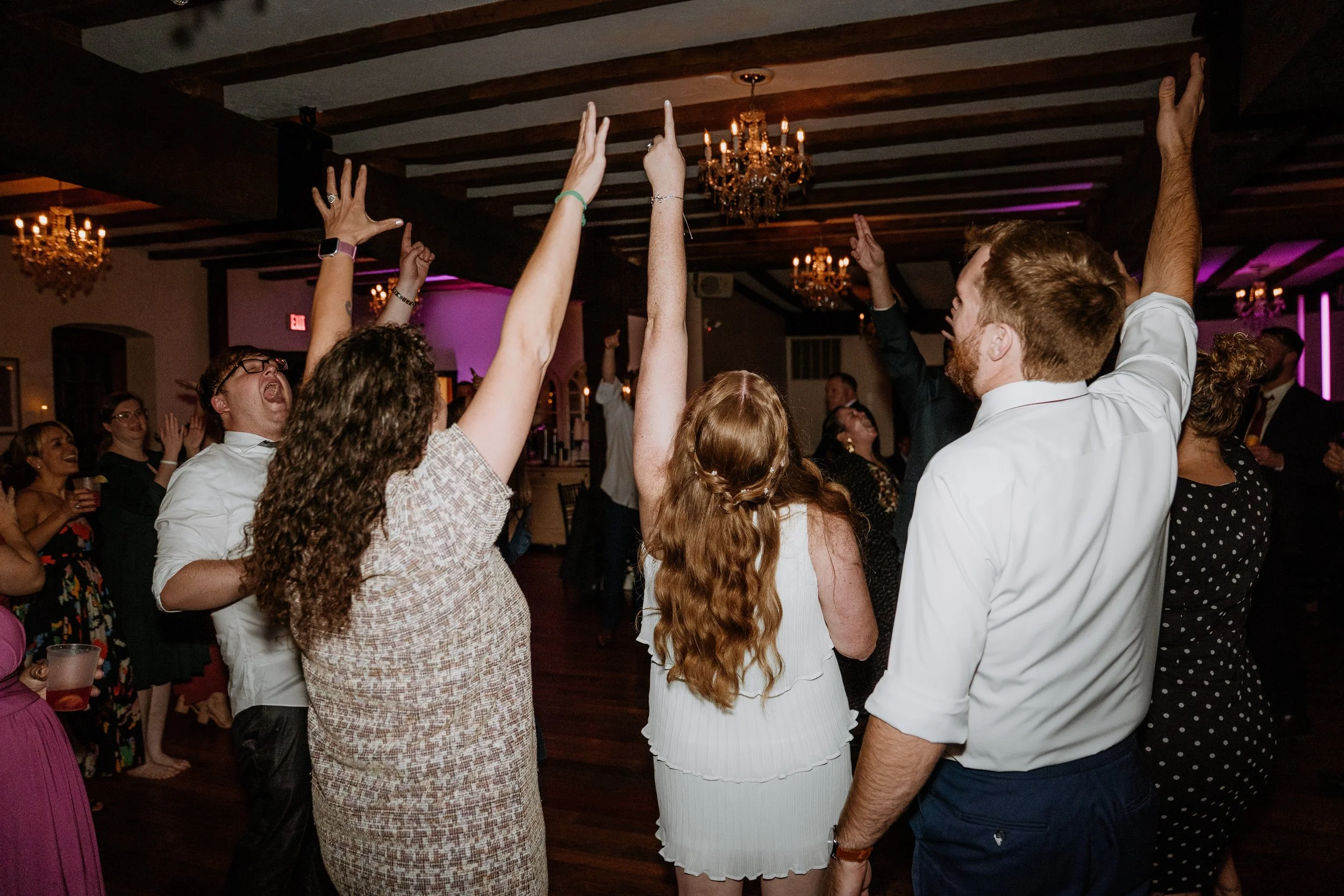 bride and groom dancing with their guests inside the historic Stone Mill Inn