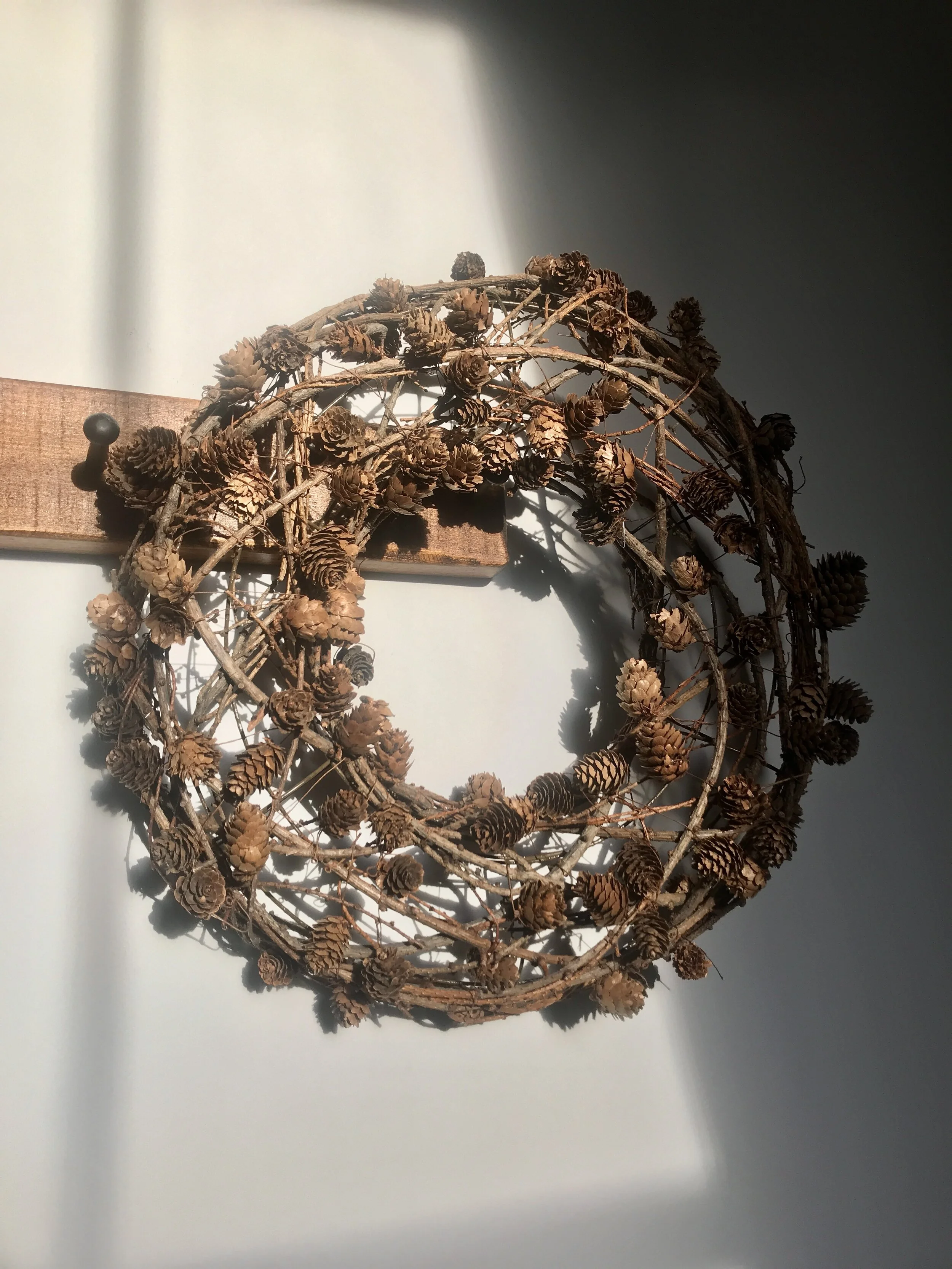 woven twig and pinecone wreath