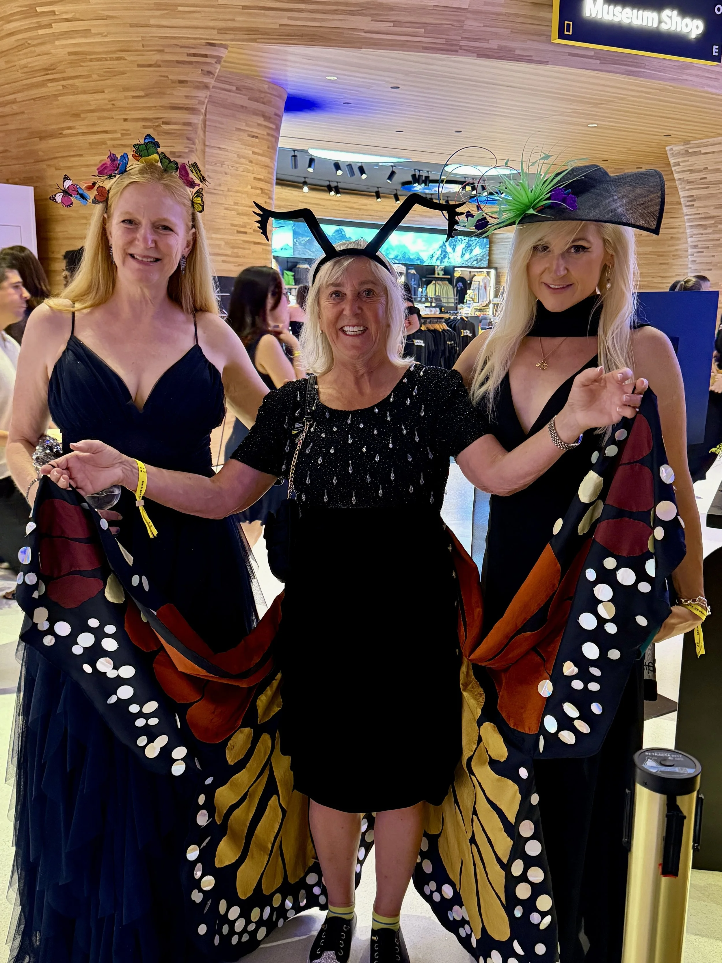 Anne A. Madden (wearing a Microbe Hat featuring a 3D print of the PCR-enabling enzyme that came from a microbe) (right), next to "Canopy Meg," National Geographic Explorer and canopy scientist Meg Lohman (center). 