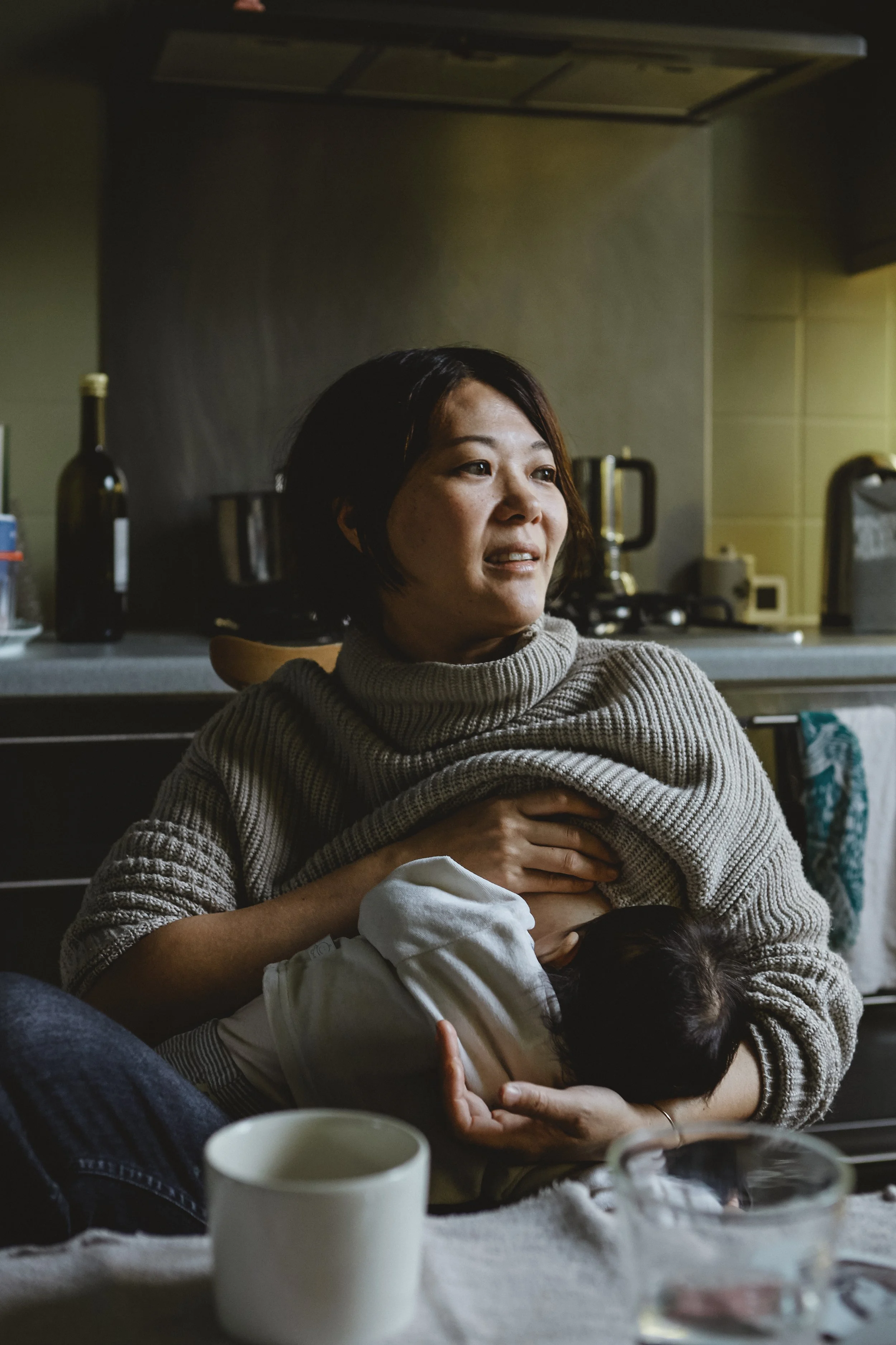 Mother baby kitchen breastfeeding natural light cosy tones east asian