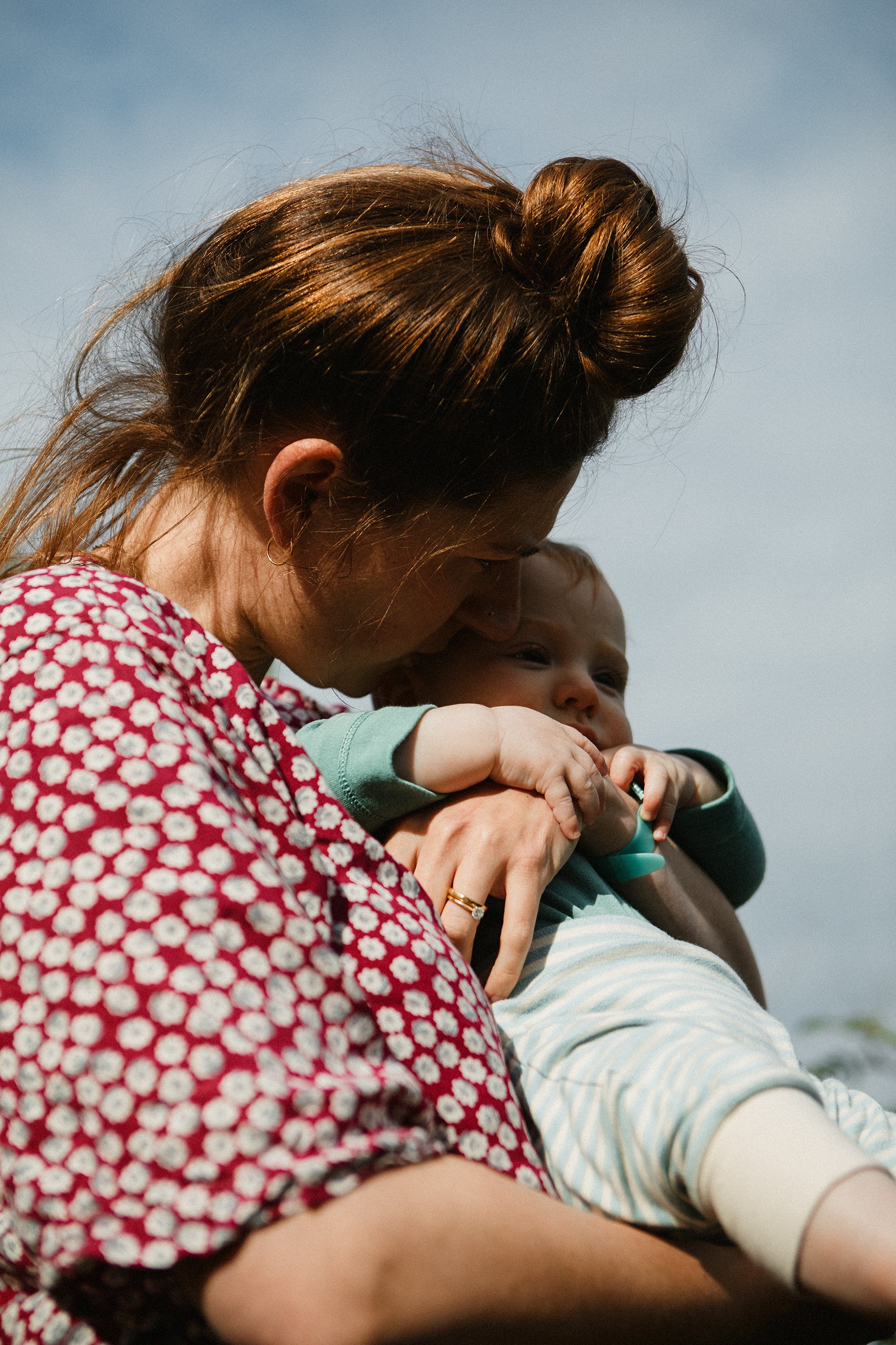 mother holding baby golden light