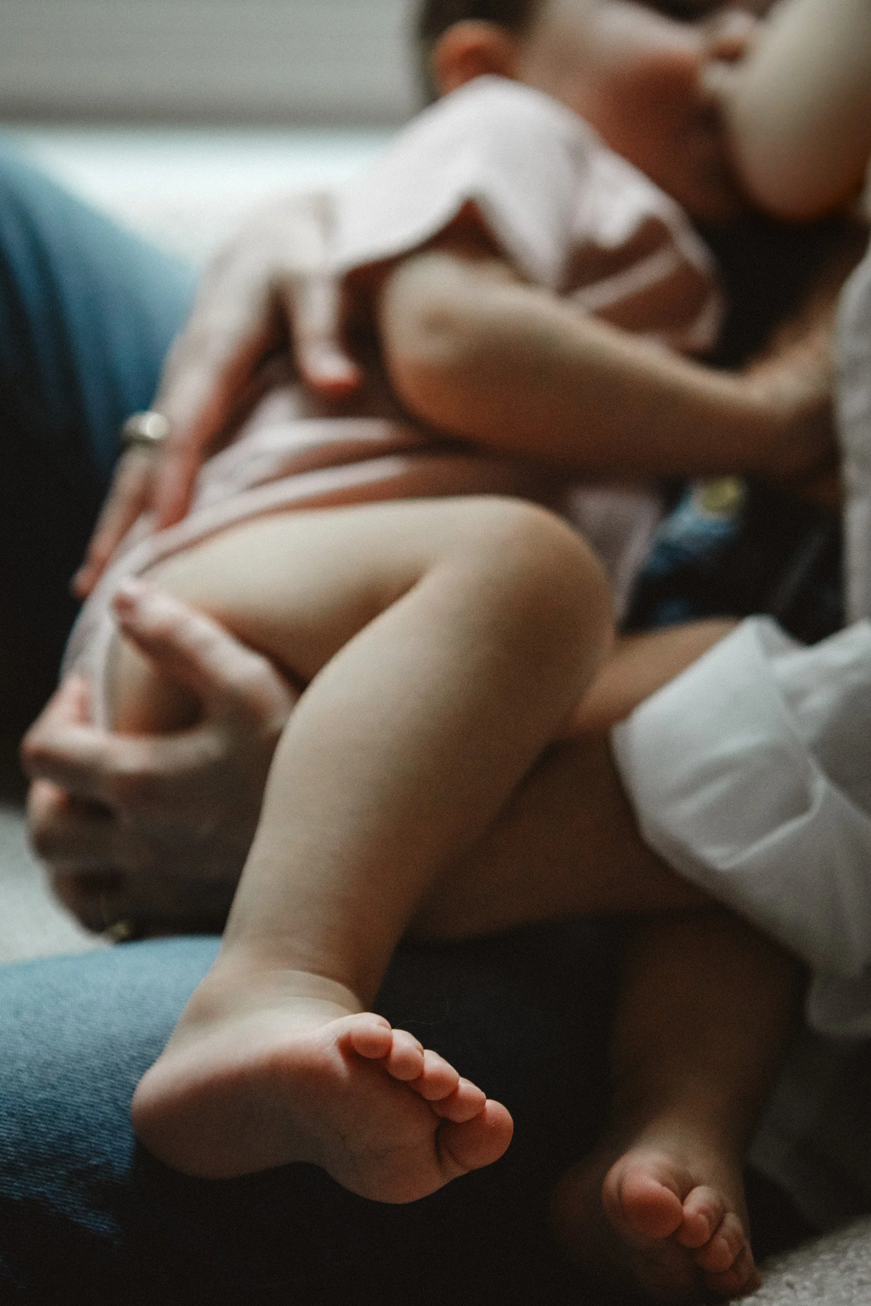 baby toes breastfeeding cuddling by window