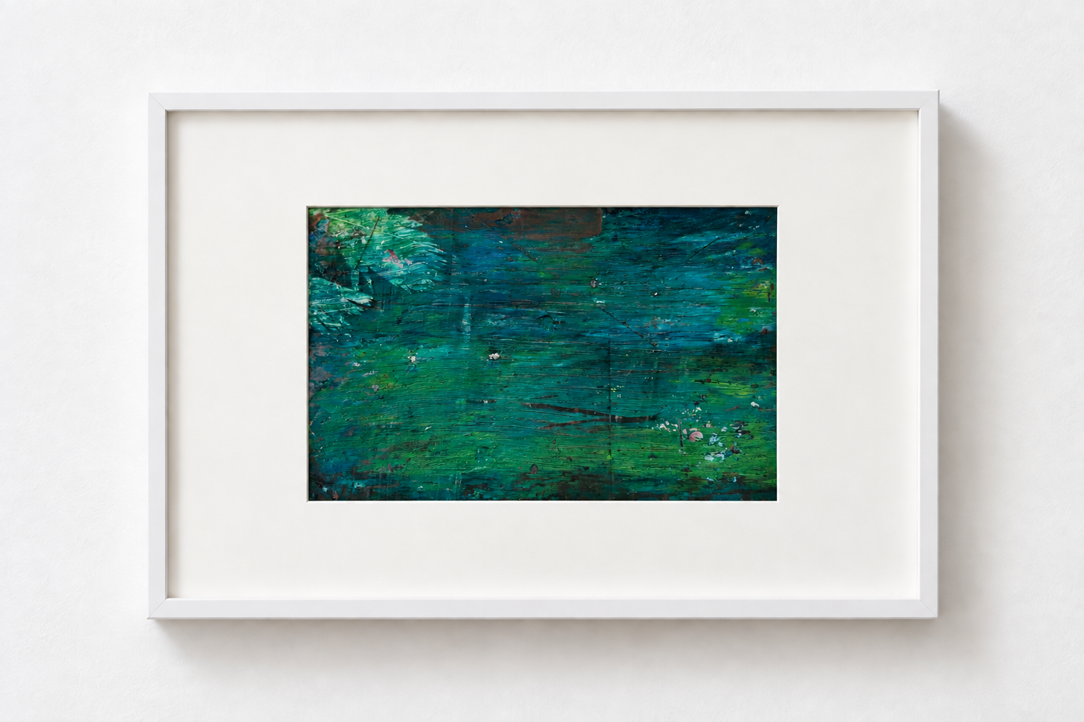 Abstract painting with shades of blue and green framed in white displayed on a white wall.