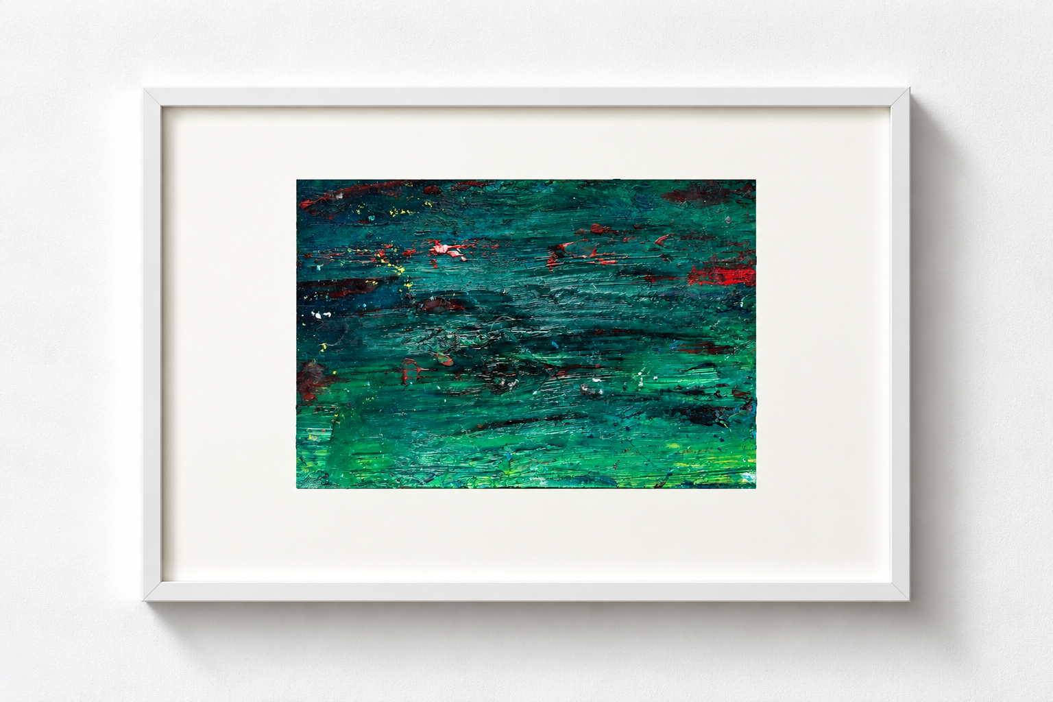 Abstract painting with horizontal brushstrokes in green, blue, and red tones framed in white, hanging on a white wall.