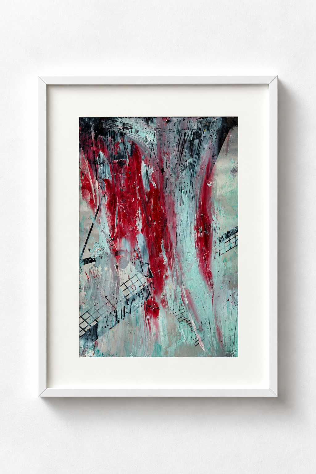 Abstract painting with red, black, and light blue colors in a white frame on a white wall.