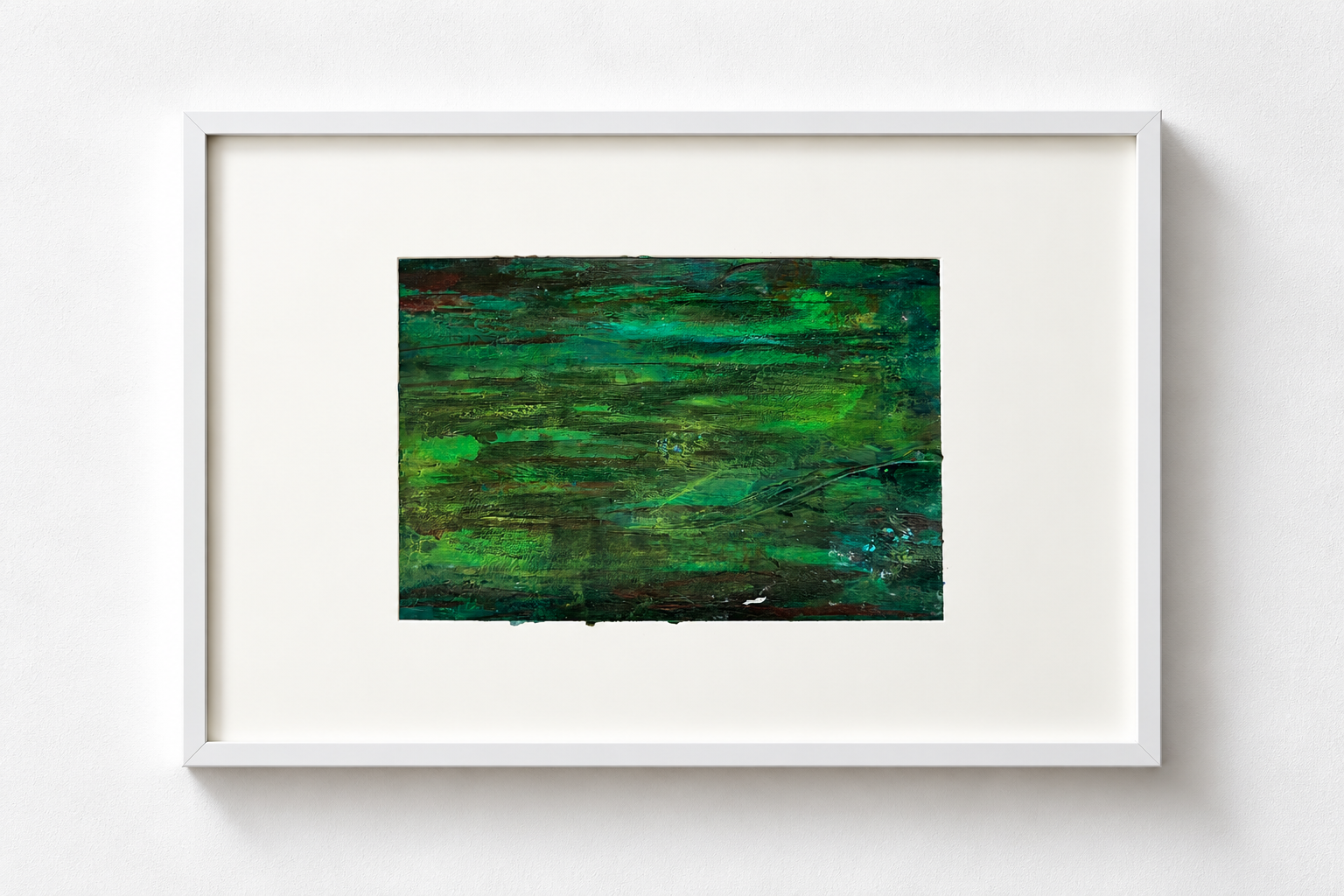 Abstract green textured painting in a white frame hanging on a white wall.