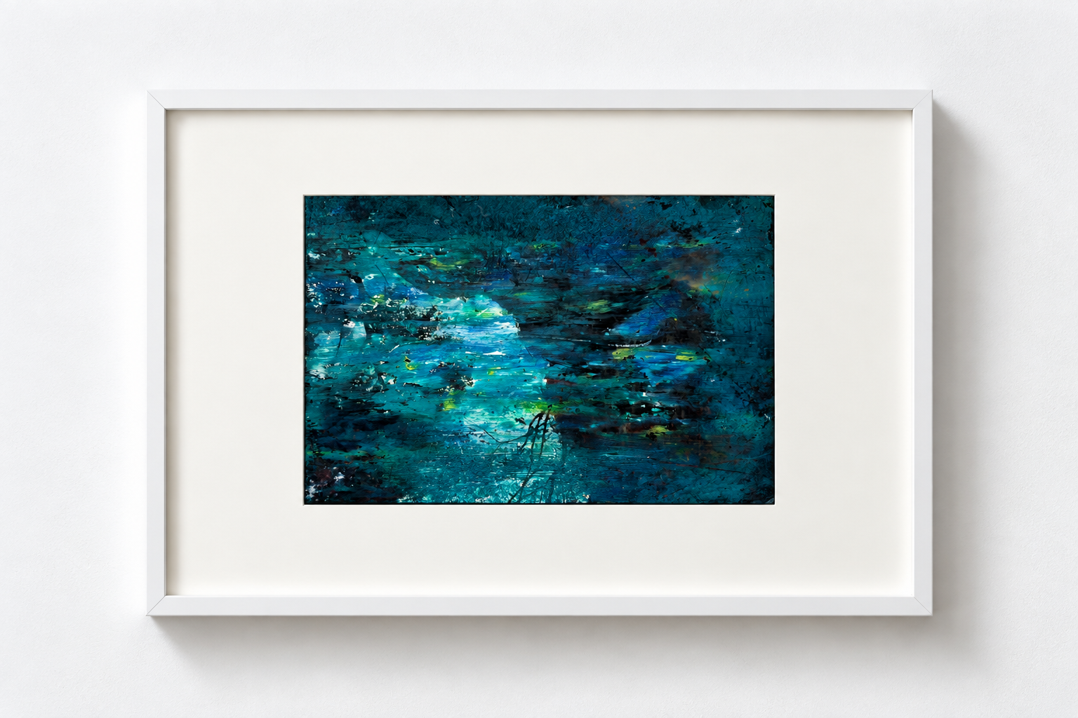 Abstract painting with blue, teal, black, yellow, and white colors in a white frame on a white wall.