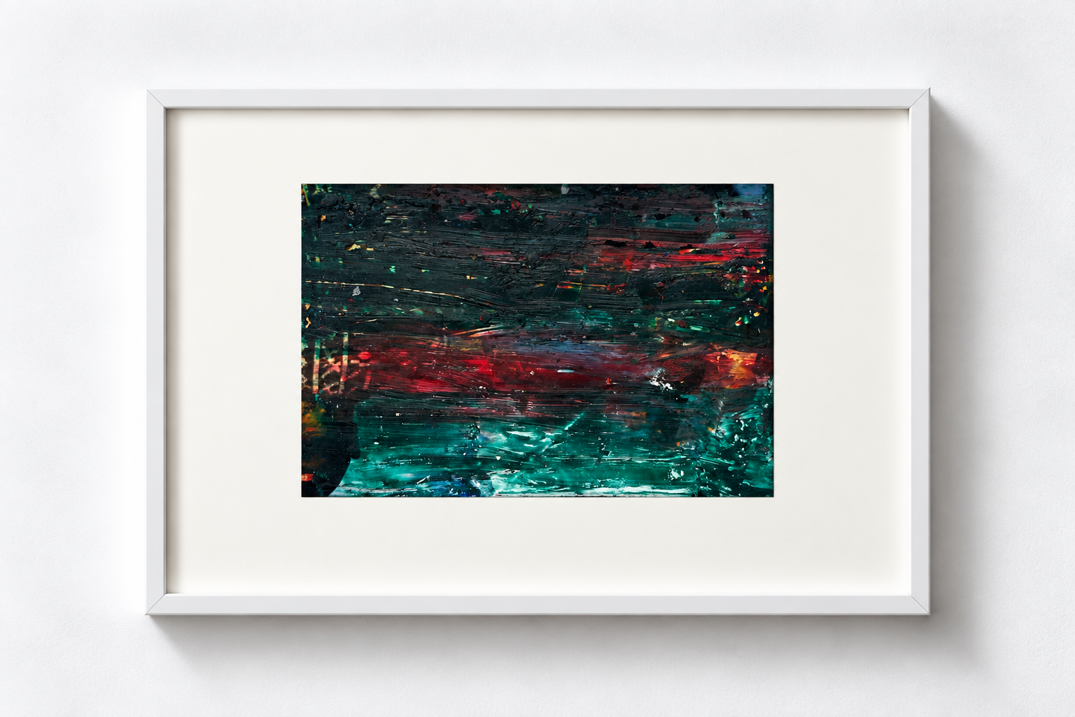 Abstract painting with dark green, red, and blue colors framed in white, hanging on a white wall.