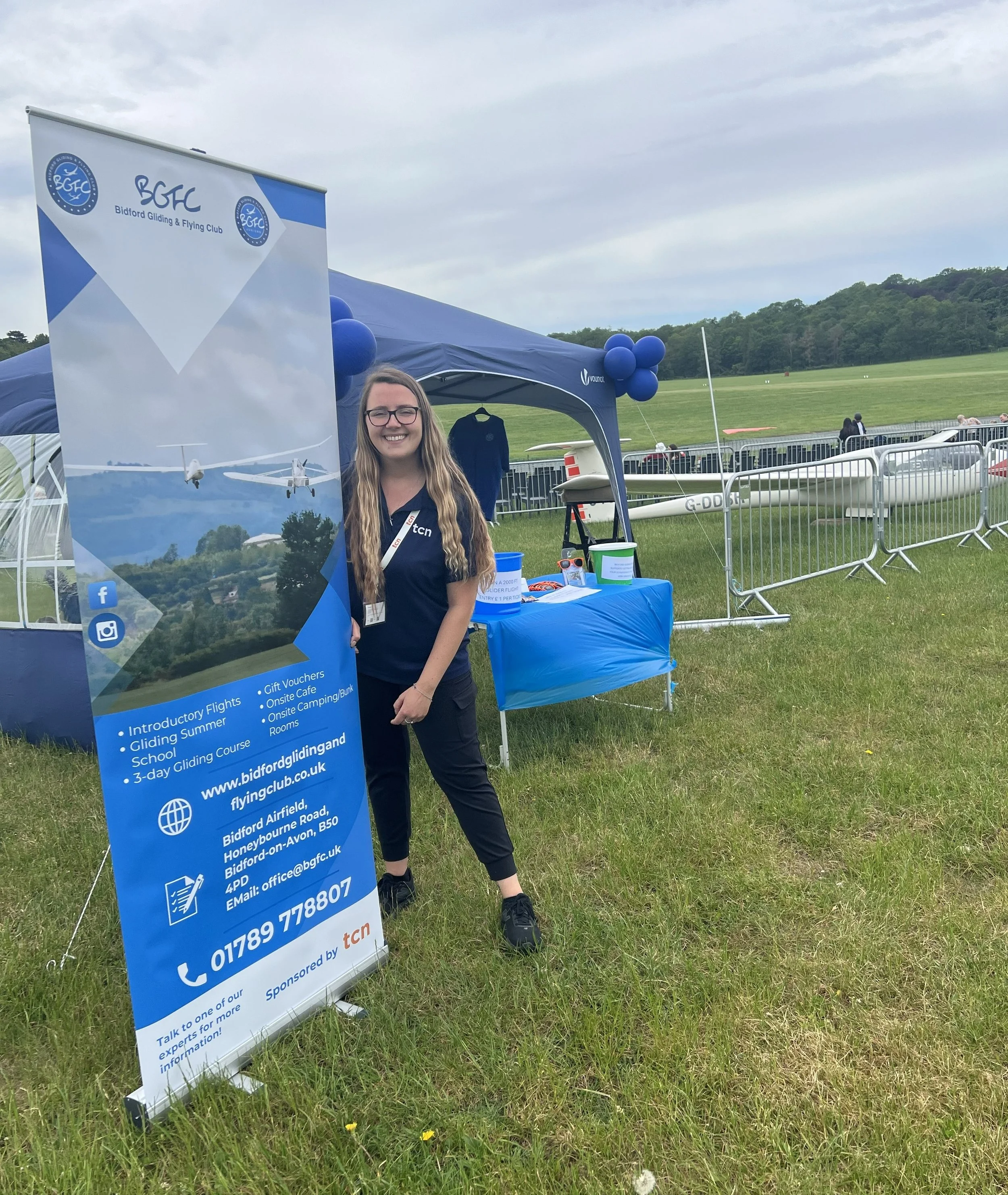 Emma with the banners she organised with her company TCN, an AI-based workflow partner