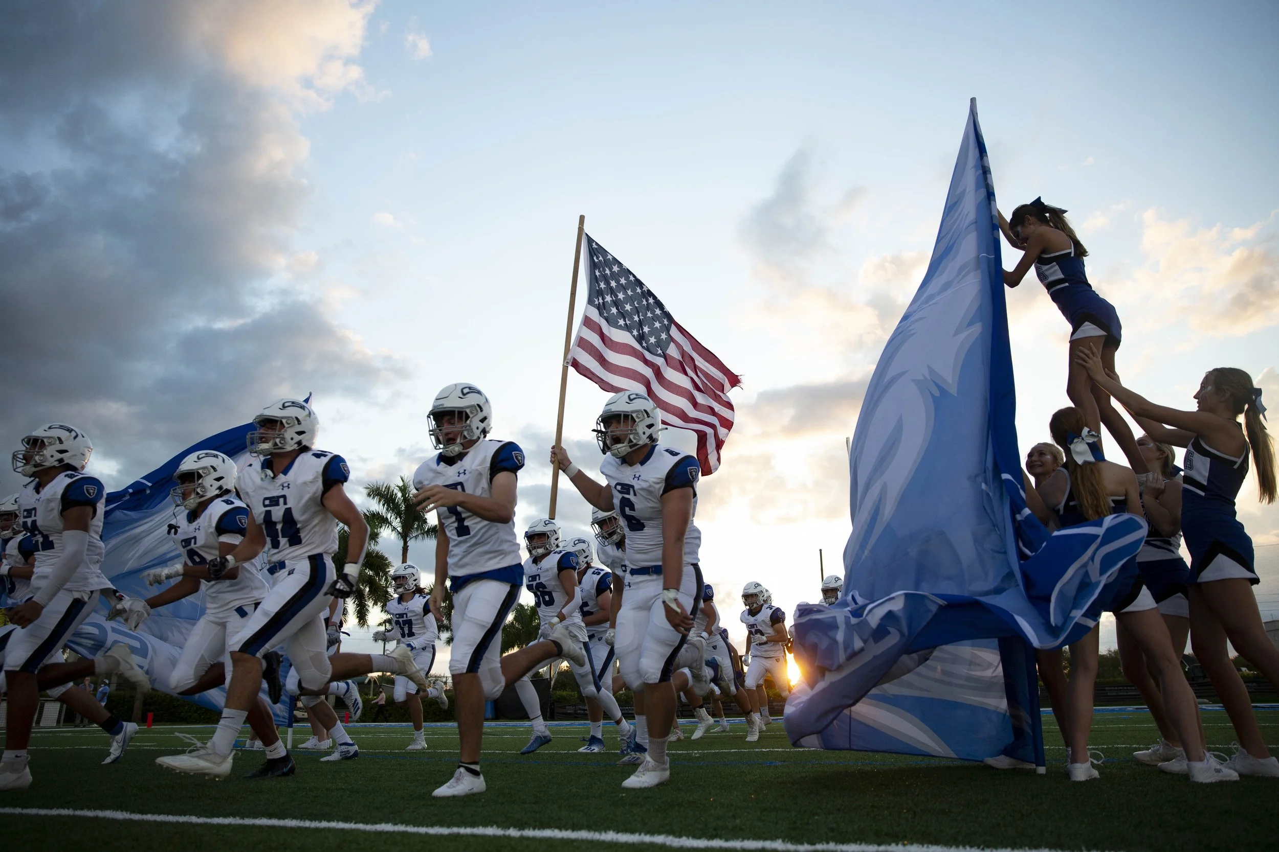  Community School of Naples football players run out before a high school football game between St. John Neumann Catholic High School and Community School of Naples, Friday, Sept. 24, 2021, at Community School in Naples, Fla.  Community School led St