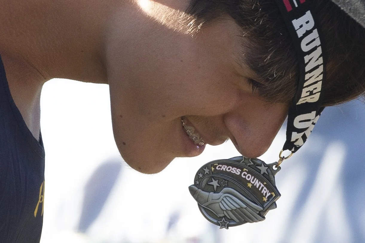  Isaiah Barajas receives a medal after placing second in the boy’s Collier County Athletic Conference cross country meet, Wednesday, Oct. 20, 2021, at Palmetto Ridge High School in Naples, Fla.  Naples High School won the boy’s and girl’s cross count