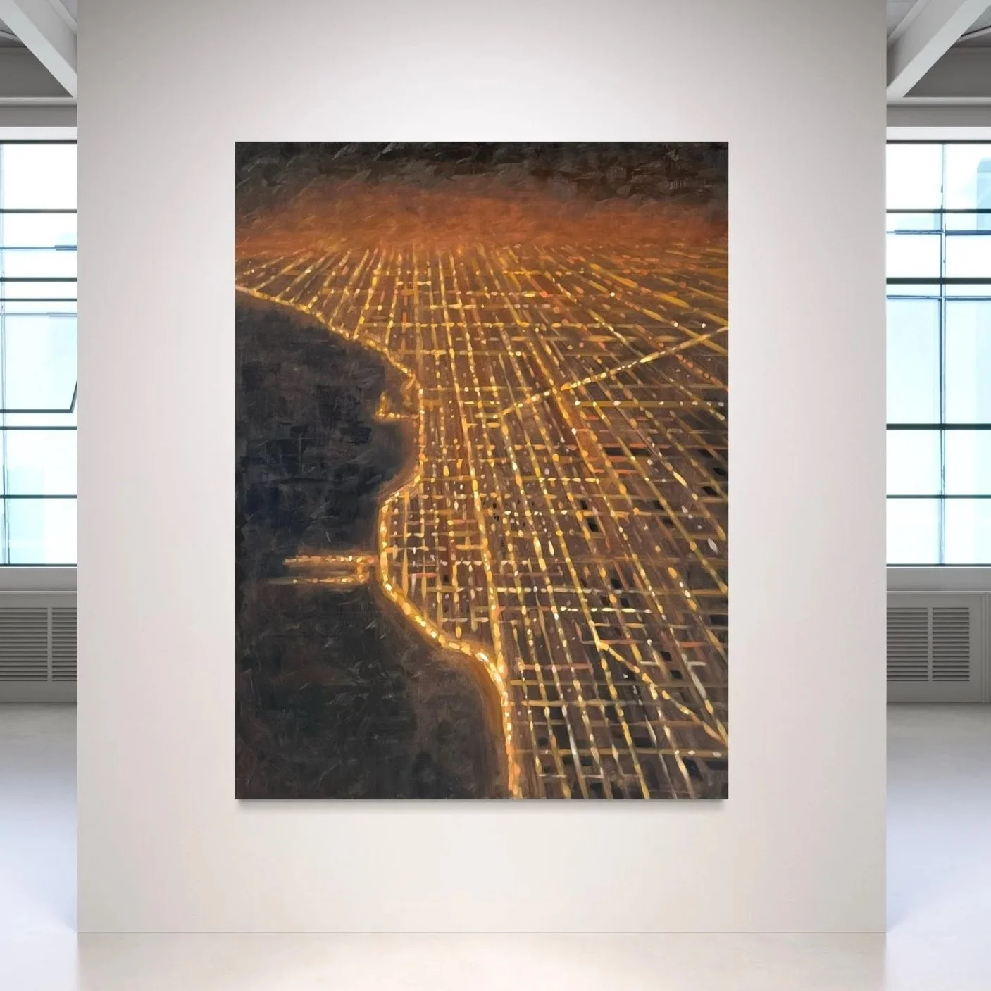 Aerial night view of a city with illuminated streets and a river borderuring it.