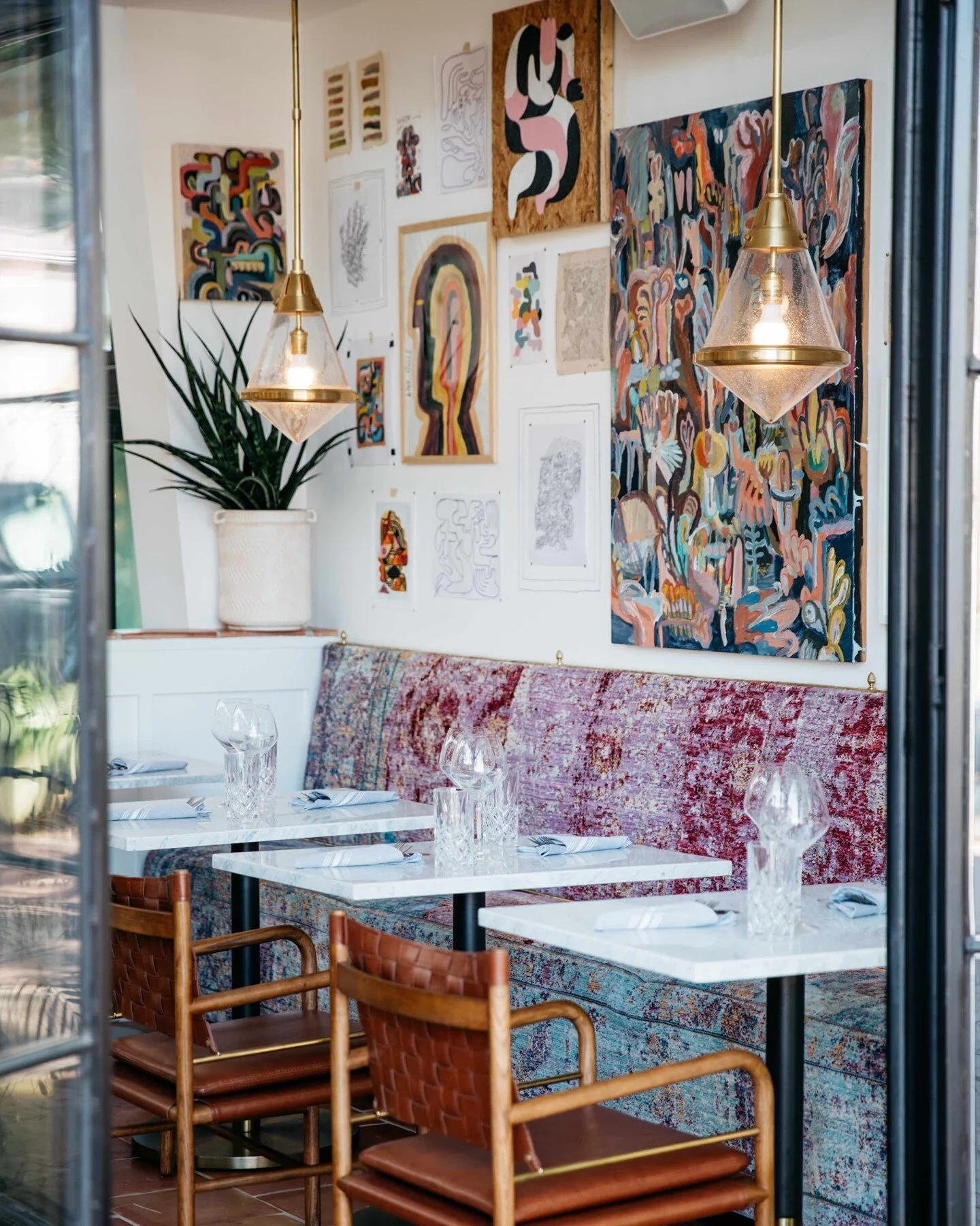 One of our favorite little nooks, the &quot;up-dining&quot; tables under the beautiful art by @kylesteed