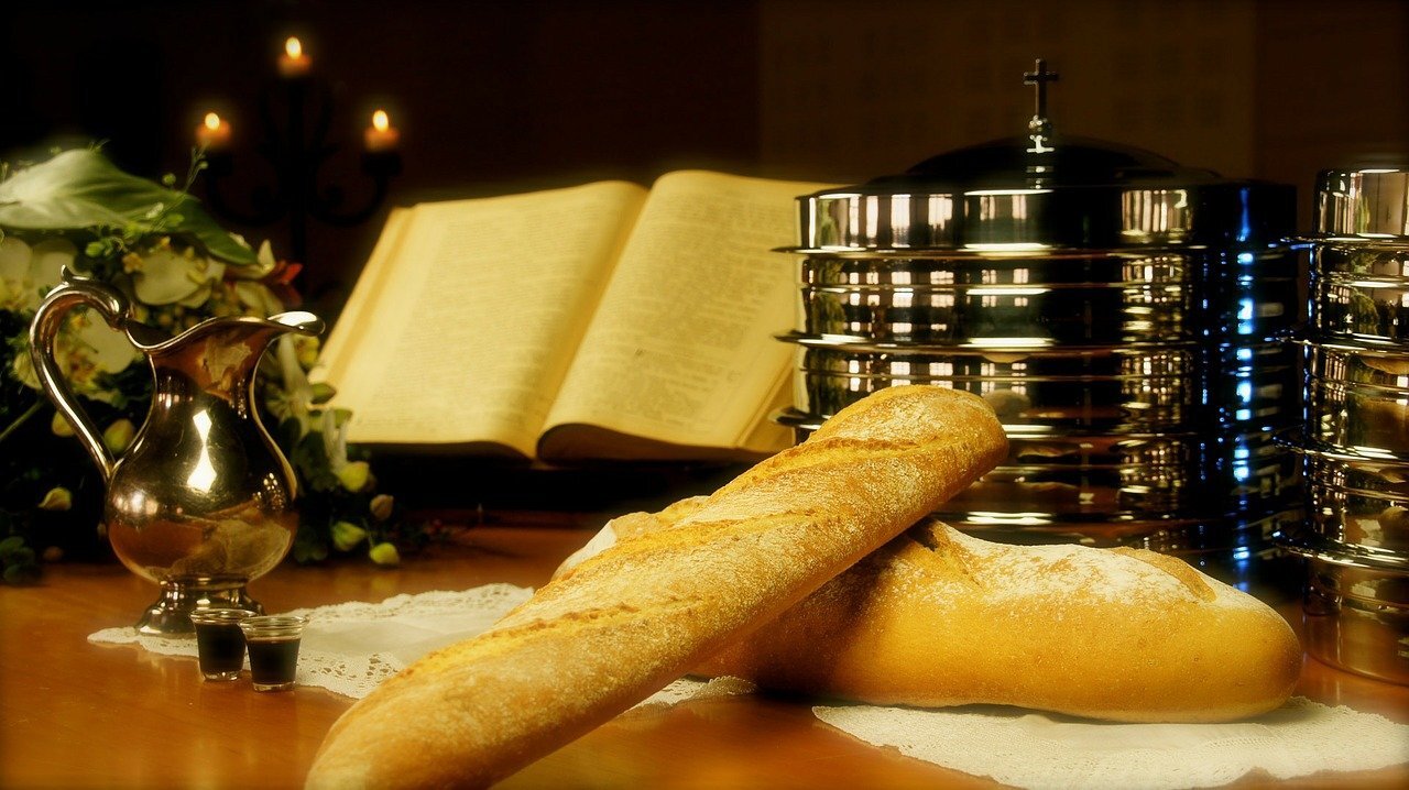 loaves of bread before an open Bible