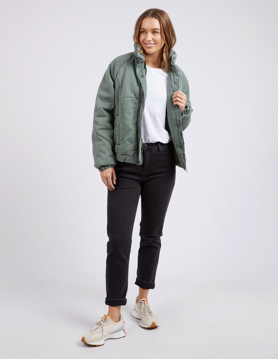 A girl wearing the washed green Rosalee jacket by Foxwood.
