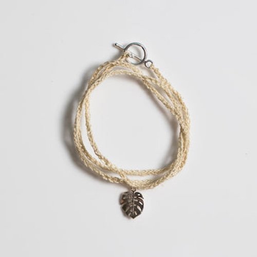 Bilum and Bilas hand woven wrap bracelet with gold palm leaf pendant.