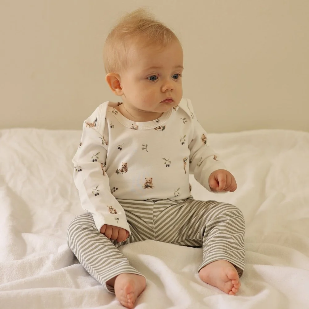 baby wearing green striped pants
