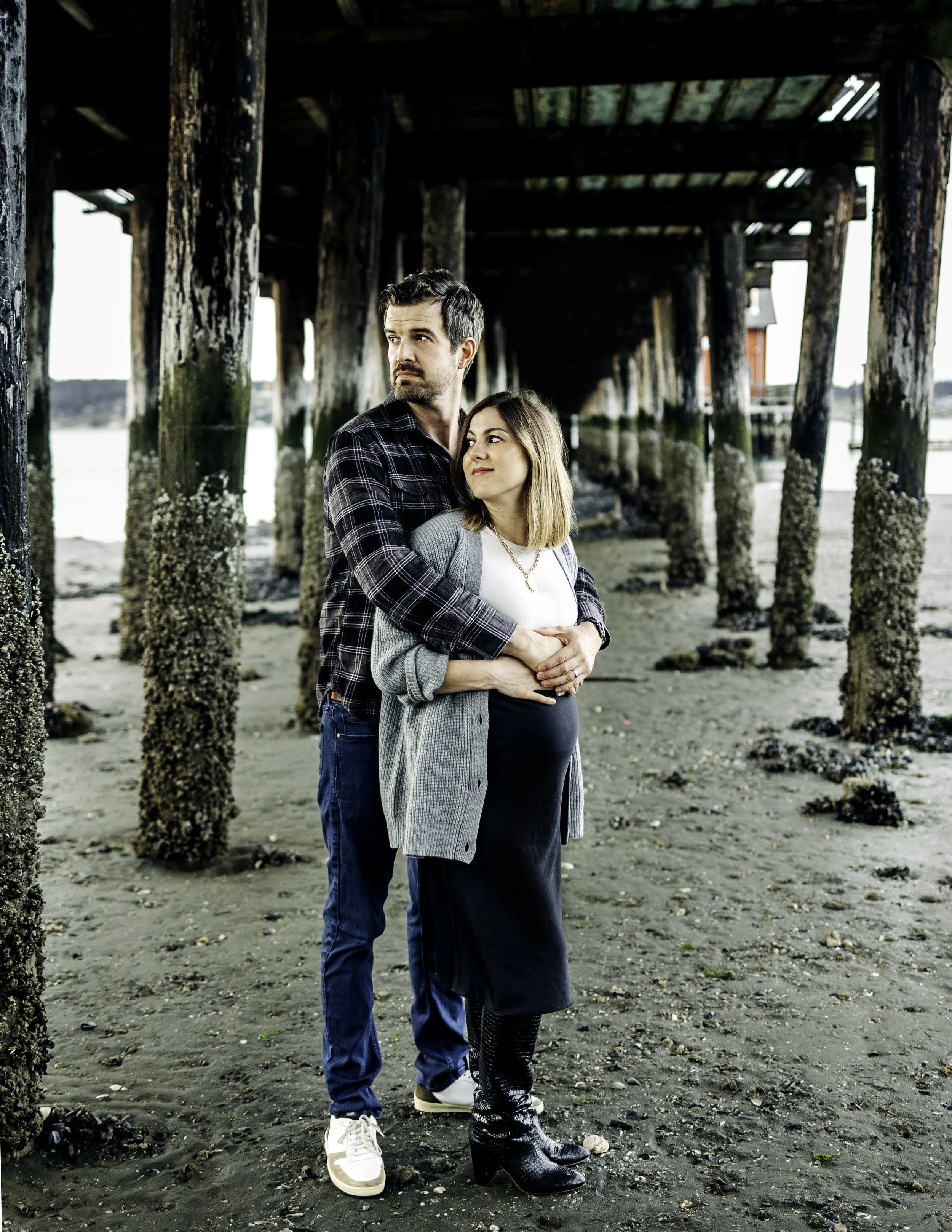 Expecting couple portrait on a beach