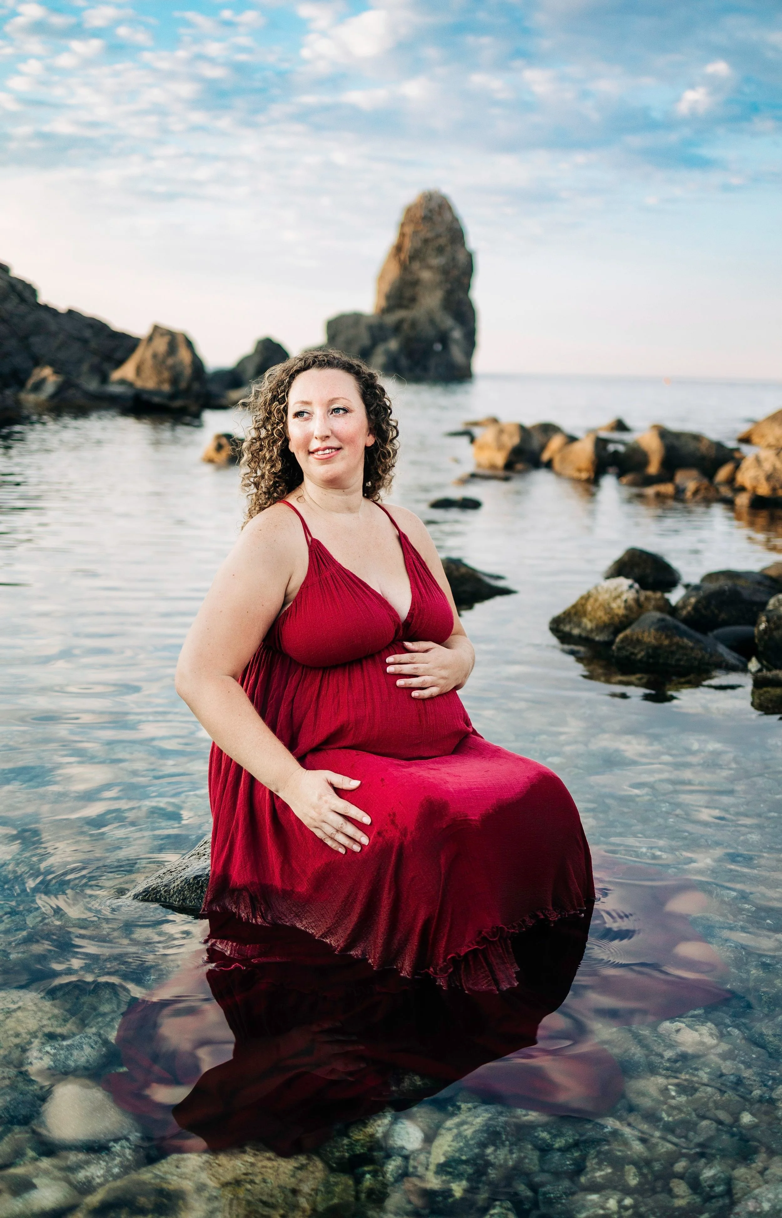 Professional portrait of a expecting mom taken at Aci Castello, Sicilly