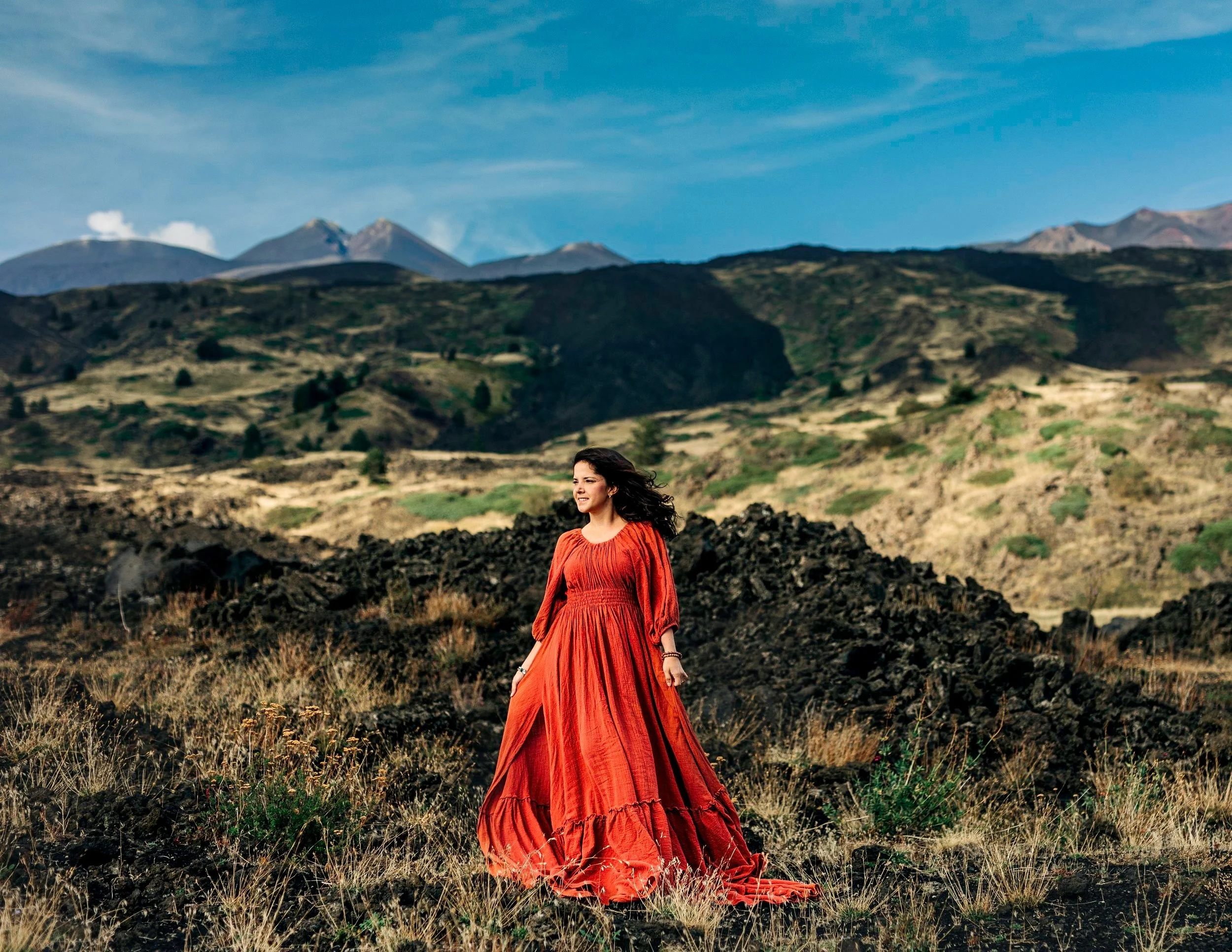 Portrait of a women in a dr3ess taken in the Etna volcano landscape in Sicily, Italy
