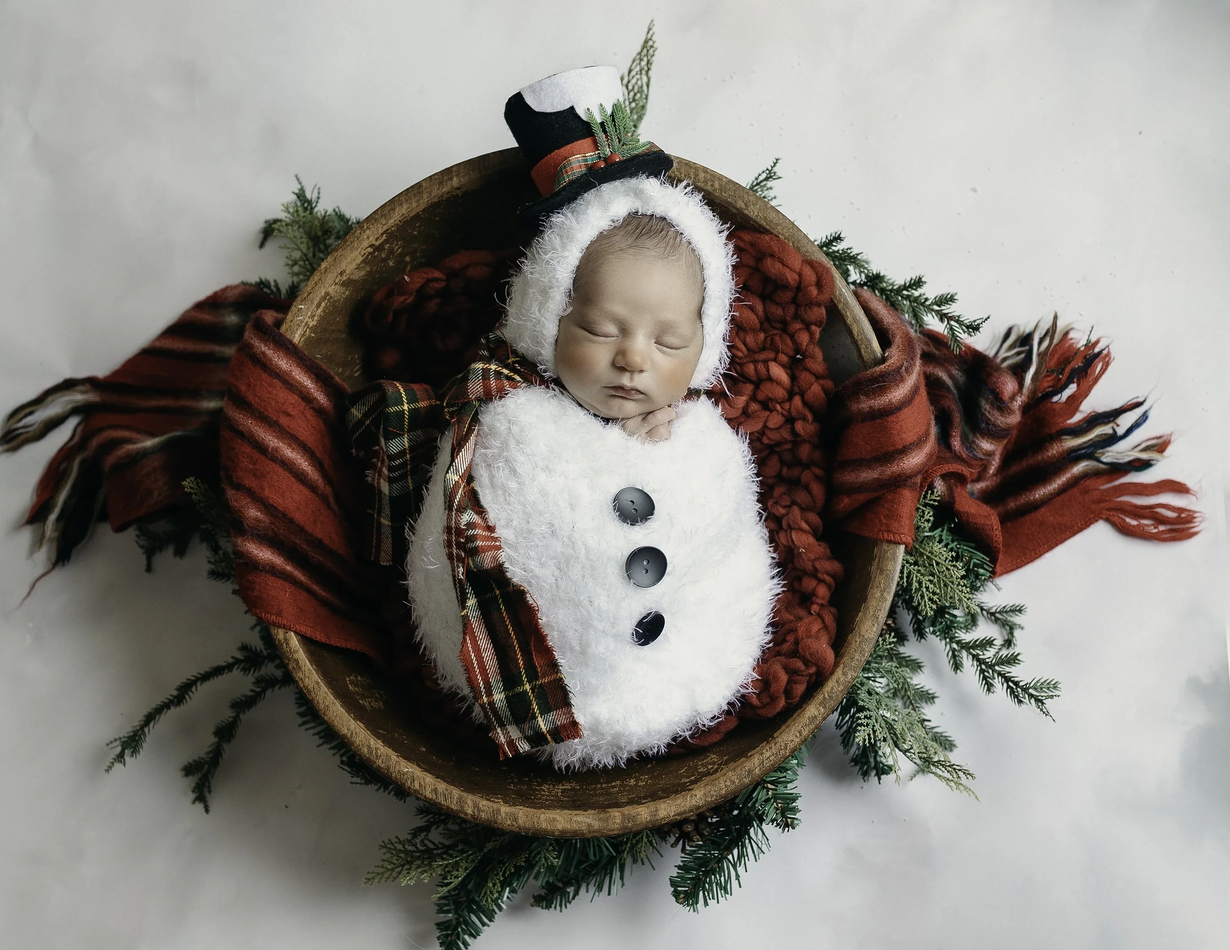 professional newborn portrait of a baby wearing a snowman suit taken in Whidbey Island WA