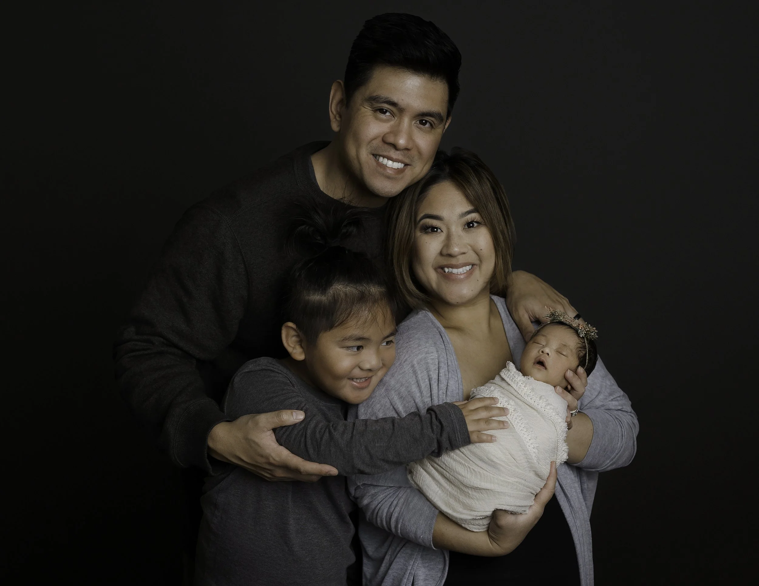 Professional studio portrait of a newborn with his family taken in Whidbey Island, WA