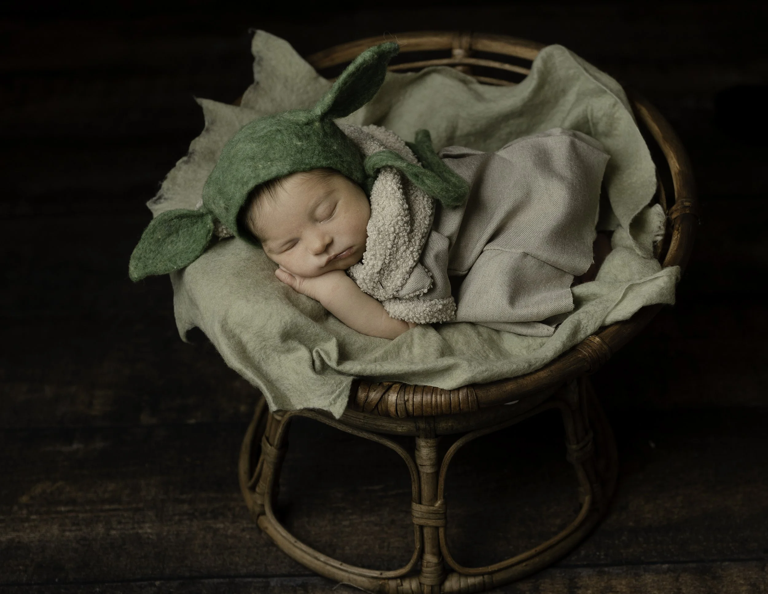 Newborn portrait of a baby dressed as baby yoda from Star Wars