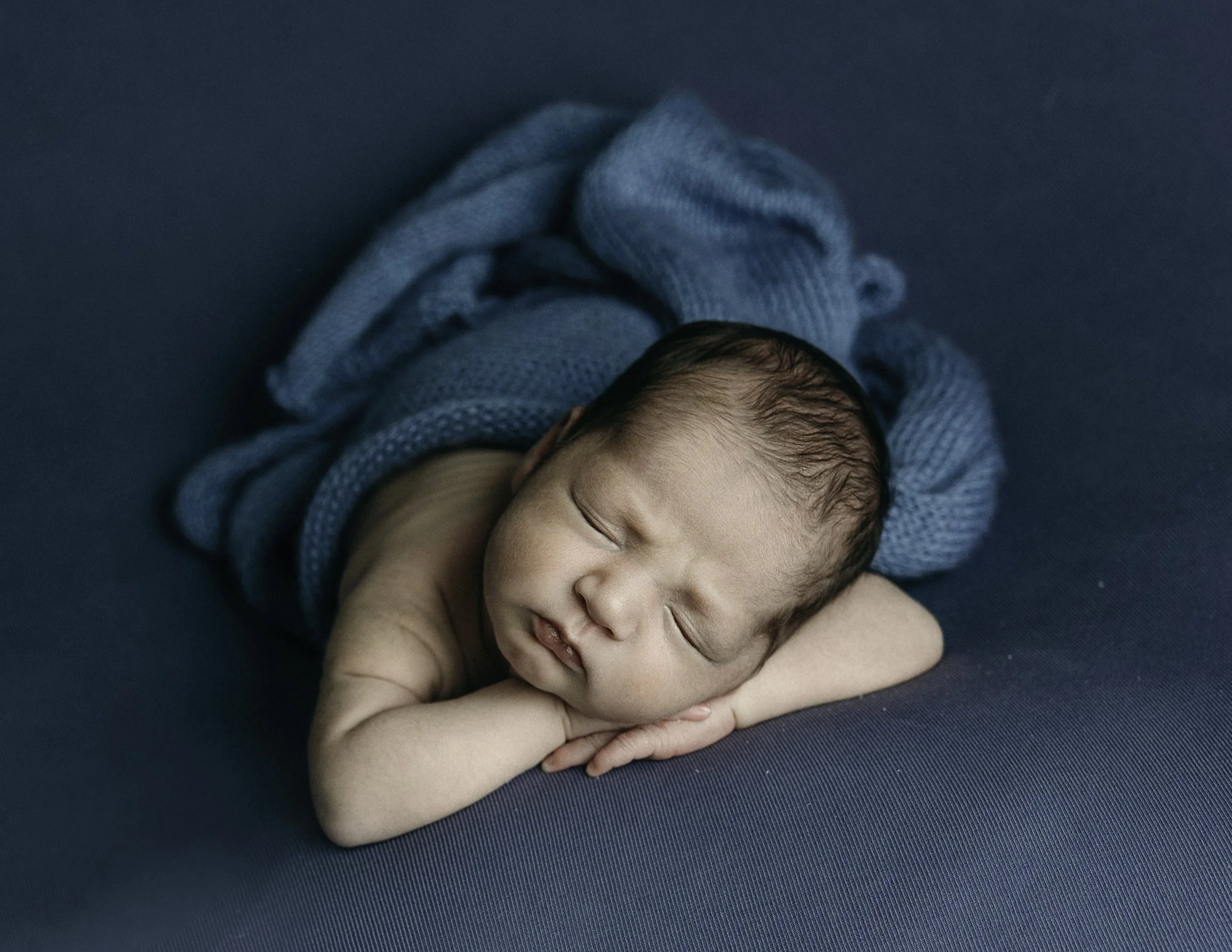 newborn photographer in whidbey island baby posed on a bean bag
