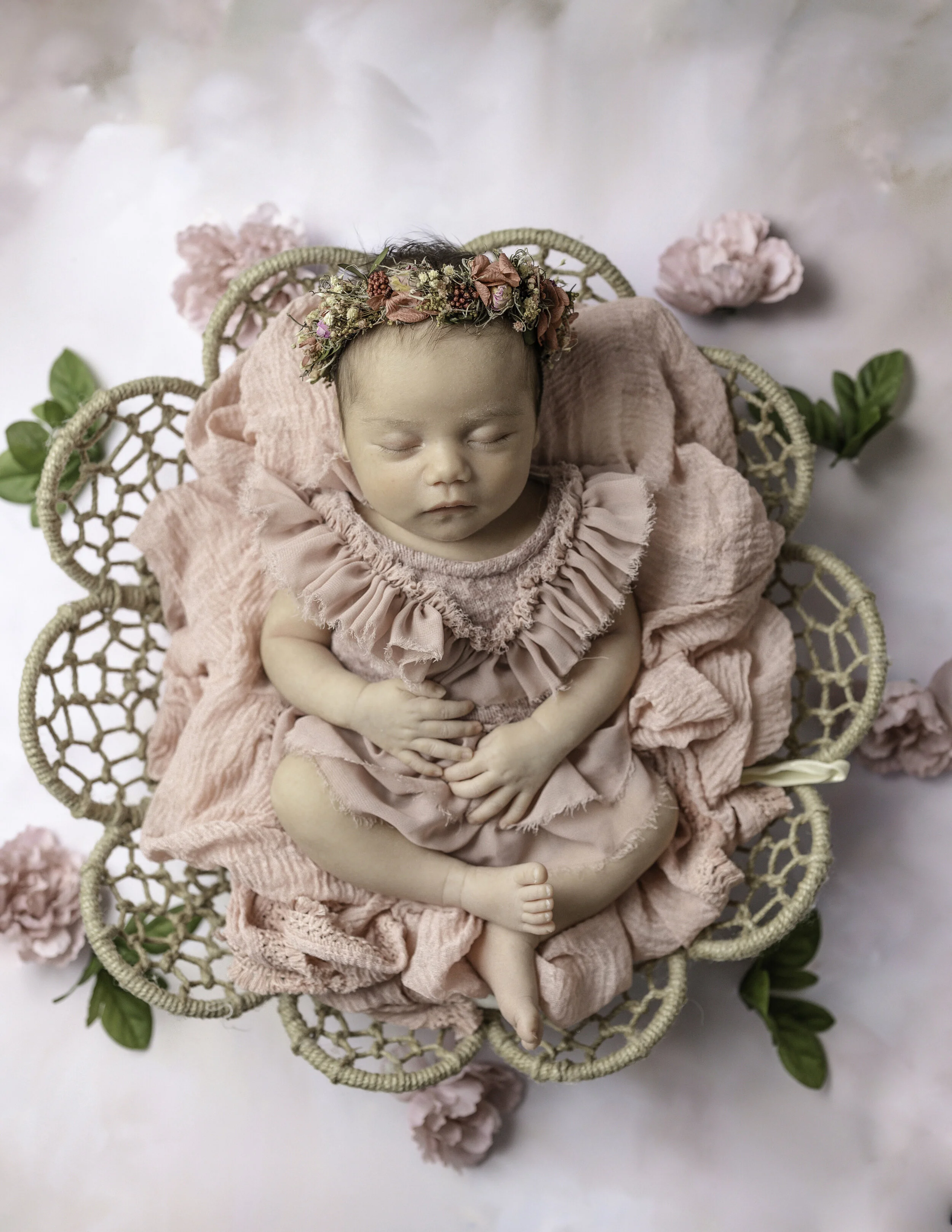 Newborn portraits of Baby girl in a flower basket