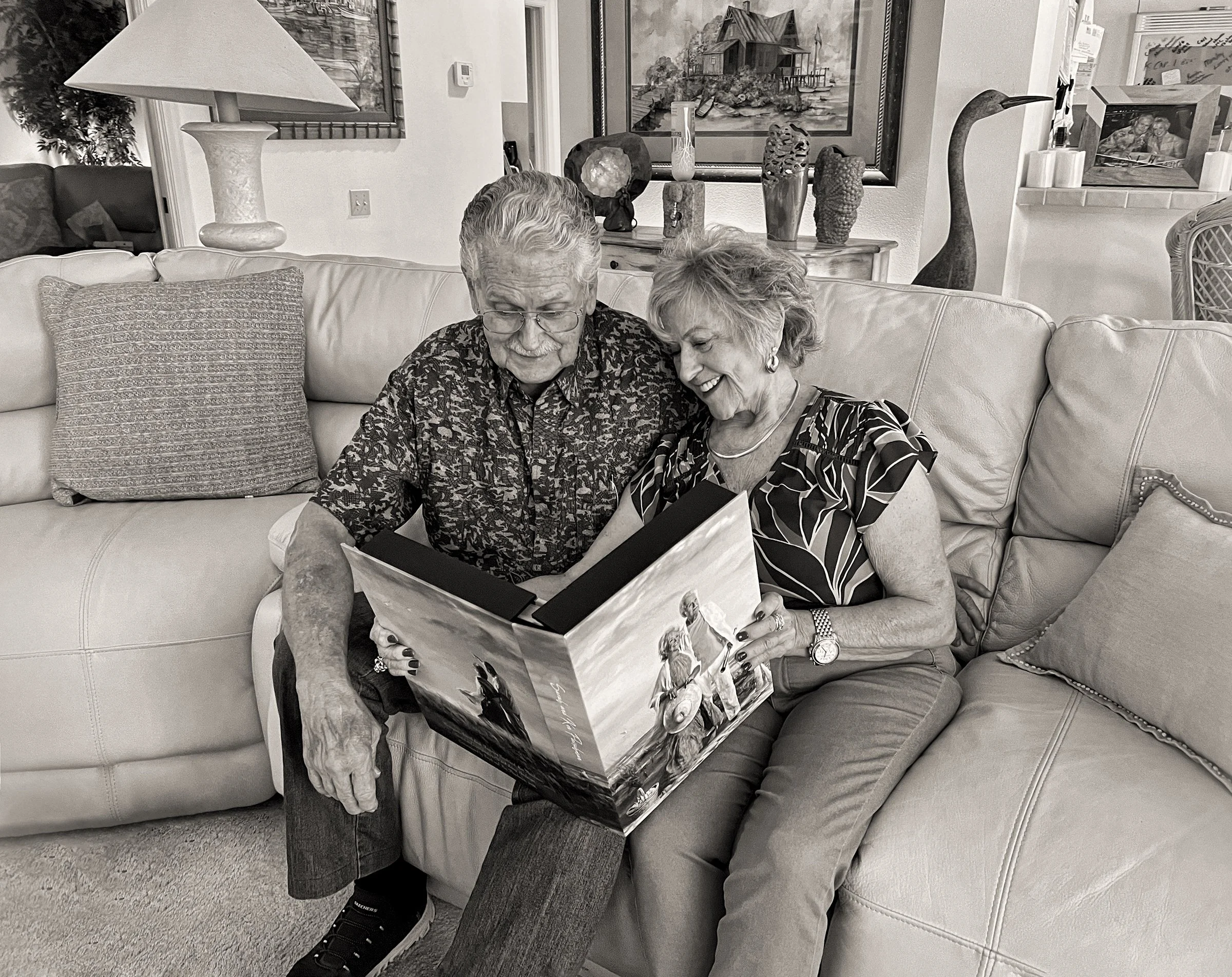 amily at home holding  Masterpiece commissioned portrait artwork book
