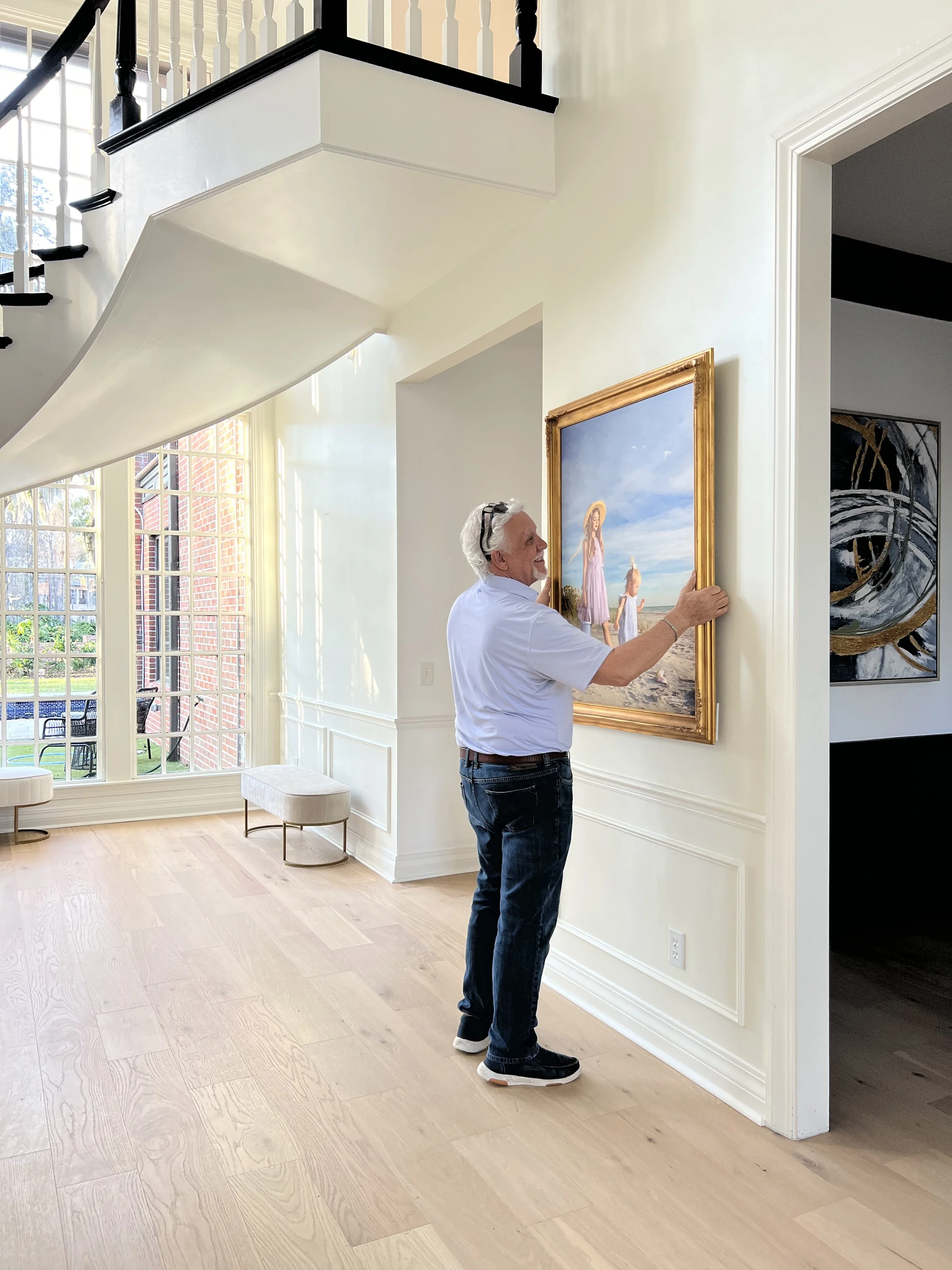 Large format commissioned family portrait artwork hanging in a luxury home interior