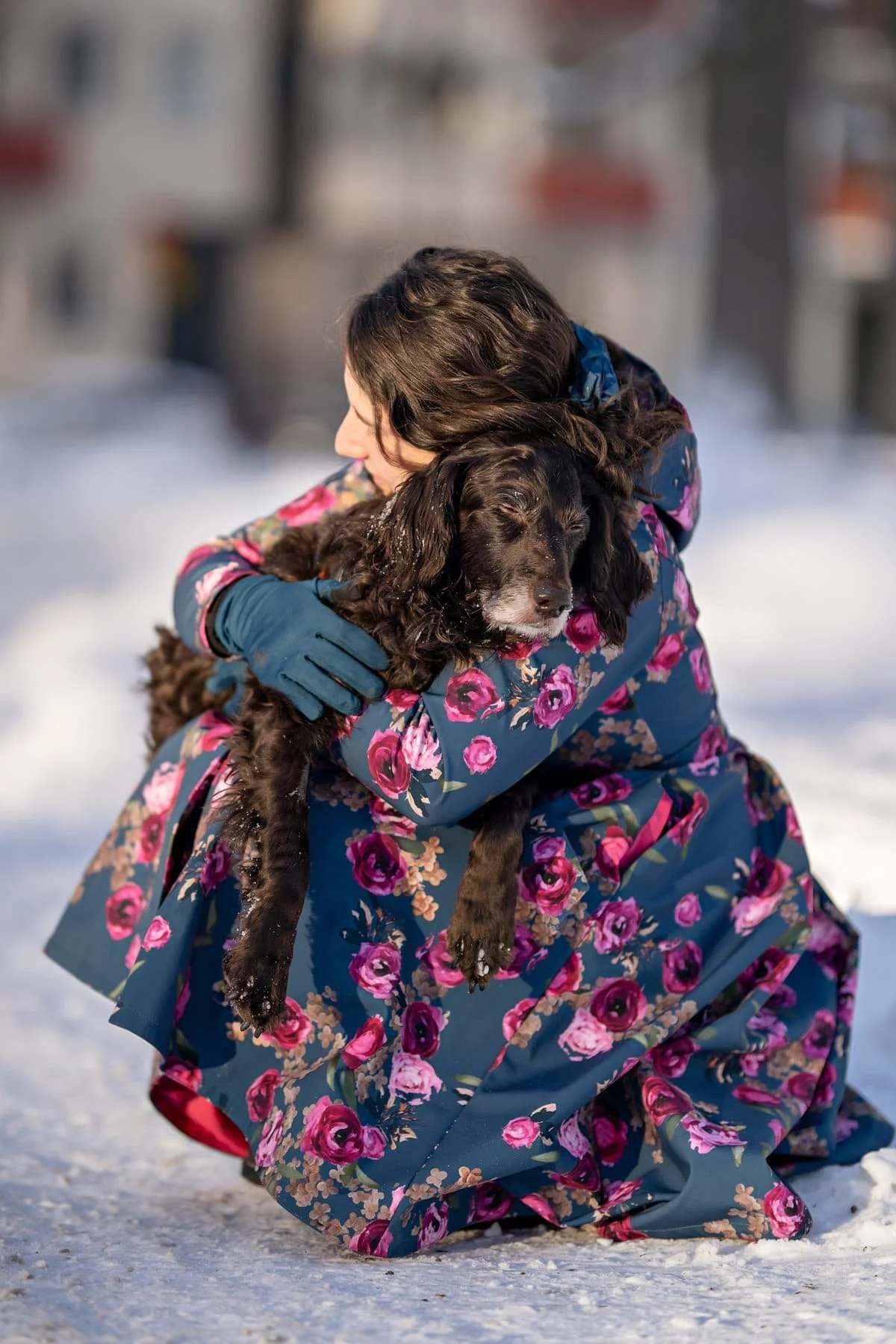 A woman holding an old dog in a end of life photography session.
