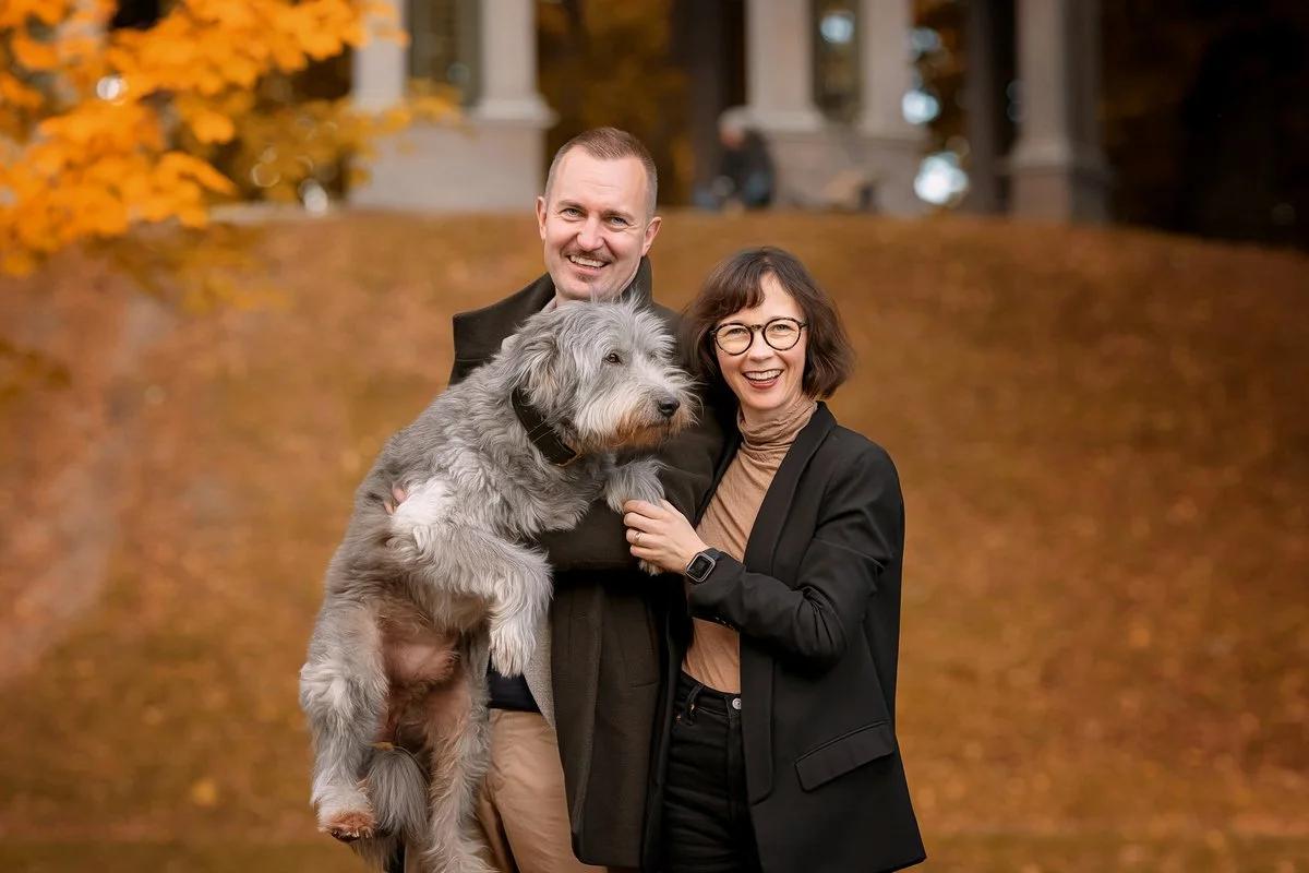 Couple with a dog posing for a professional dog photographer in Stockholm