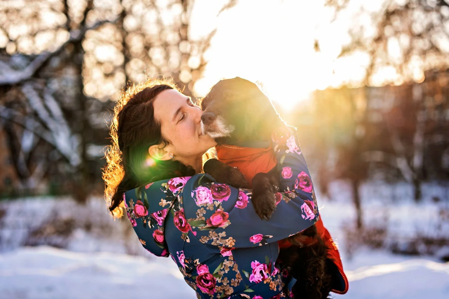 A woman holding an old dog in a end of life photography session.