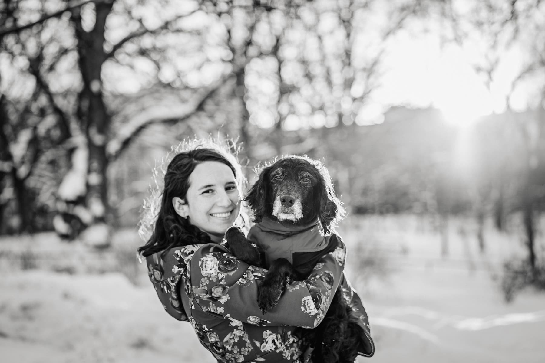 A woman holding an old dog in end of life photography session in Stockholm