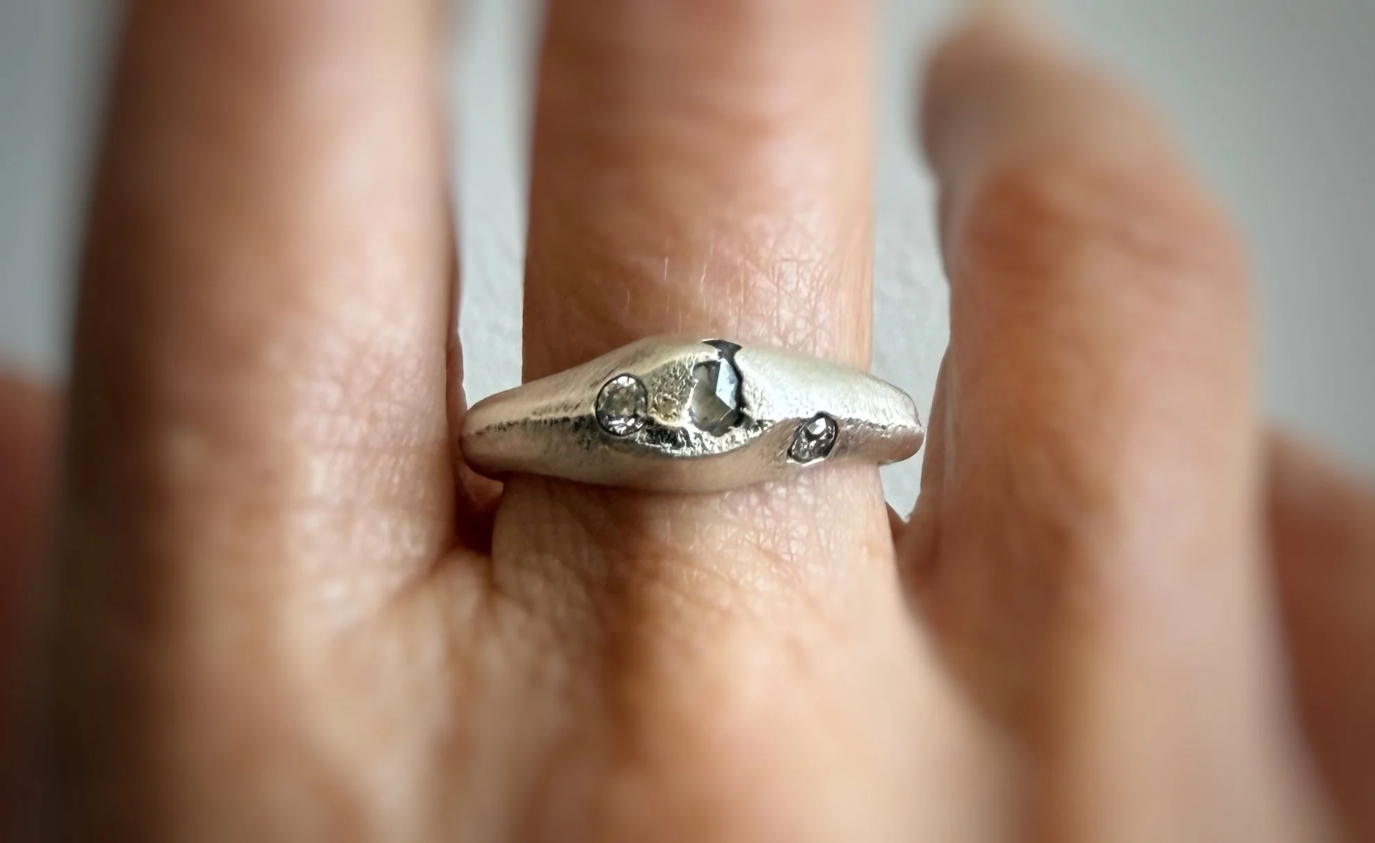 sand cast sterling silver ring with sapphire moisaanites